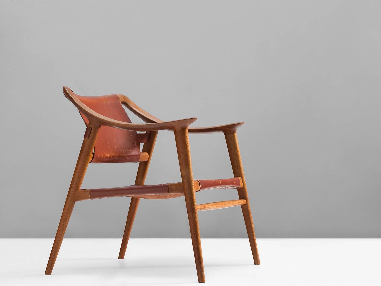 Armchair model 56/2 'Bambi', in teak and leather, by Rolf Rastad & Adolf Relling for Gustav Bahus, Norway, circa 1954. 

Excellent example of the 'Bambi' chair of Rolf Rastad and Adolf Reling. This edition consist of a teak frame and cognac