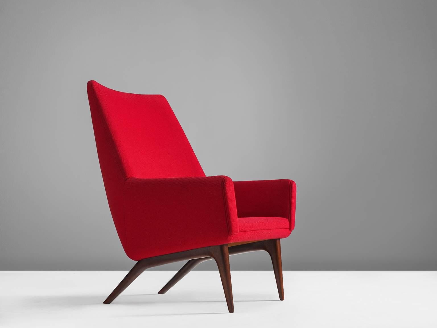 Lounge chair, red fabric and wood, Denmark, 1960s

This armchair with tilted back features clean lines and geometric shapes combined with playful, tapered legs that show a reference to saber legs. The style of this chair shows traits of the designs