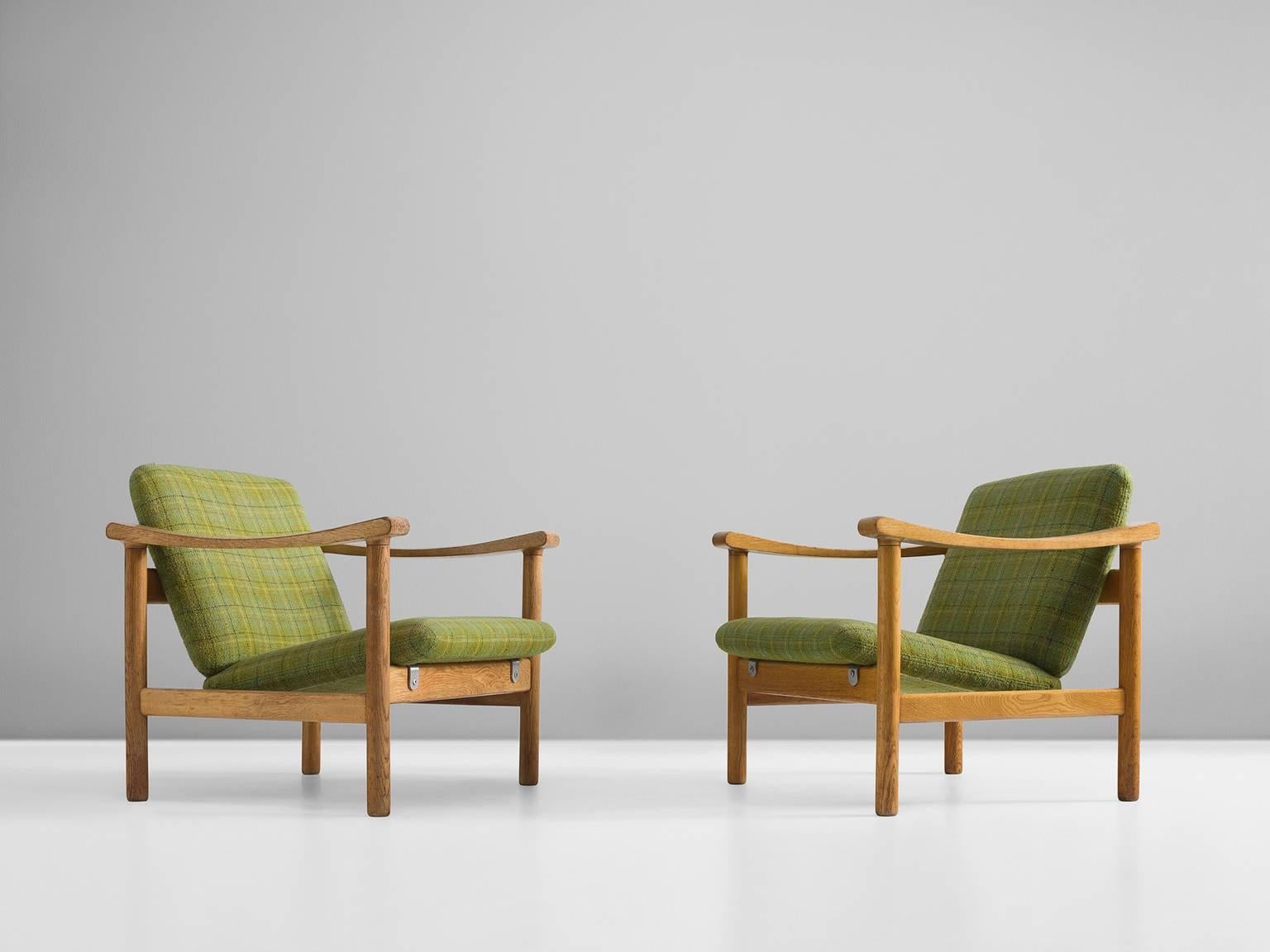 Set of GE280 lounge chairs, green checked fabric and oak, Hans Wegner for Getama, Denmark, 1950s

This Danish set of lounge chairs is both clean and minimalistic in its design. At the same time these two chair feature specific details in order to