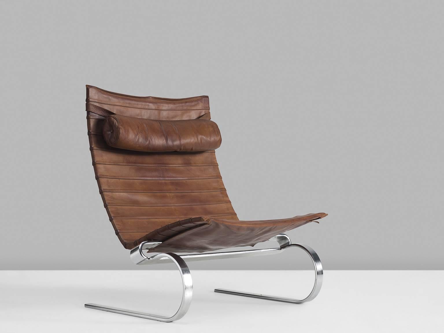 Lounge chair PK20, in stainless steel and brown to cognac leather, by Poul Kjærholm for E. Kold Christensen, Denmark, 1968.

Cantilevered easy chair designed by Poul Kjærholm for E. Kold Christensen. This reclining chair is made of matte,