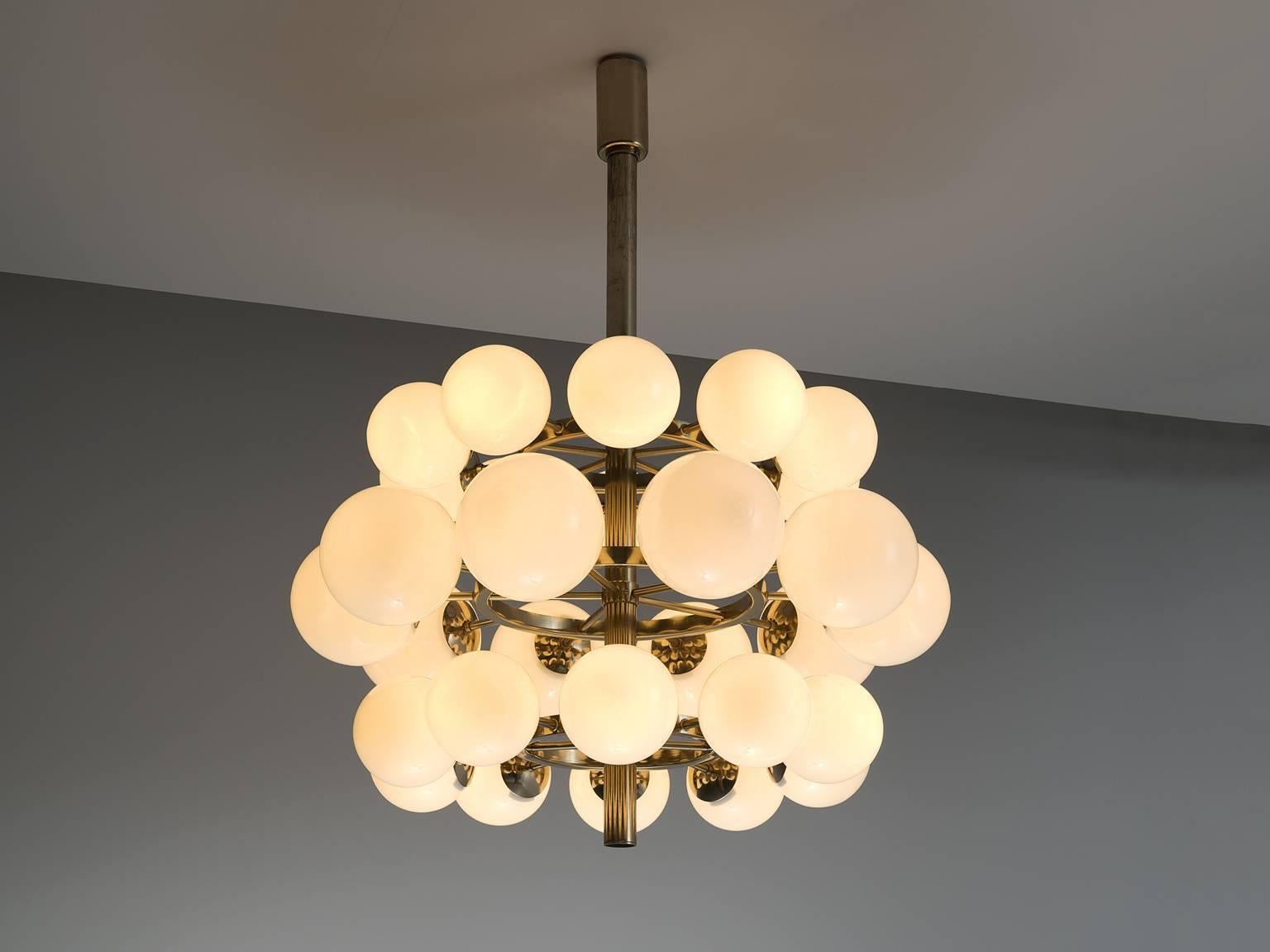 Sputnik chandelier, in brass and opaline glass, Europe, 1970s. 

This triple layered Sputnik has 30 opaline glass globes. The chandeliers consist of a brass fixture with thirty arms, all with an opal sphere. Due the opaque glass this chandelier