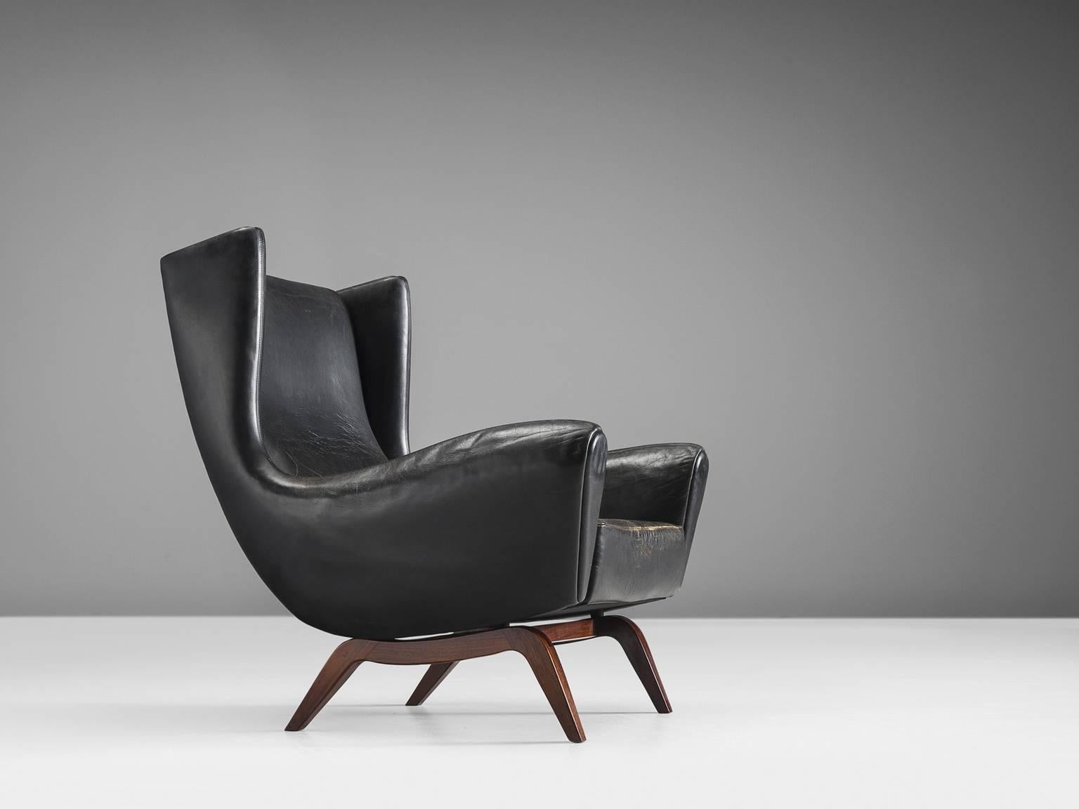 Lounge chair 'Model 110', in teak and black leather by Illum Wikkelsø for Søren Willadsen, Denmark, 1950s.

This well-designed armchair shows an unusual elegance and great eye for detail, combined with outstanding craftsmanship, which is