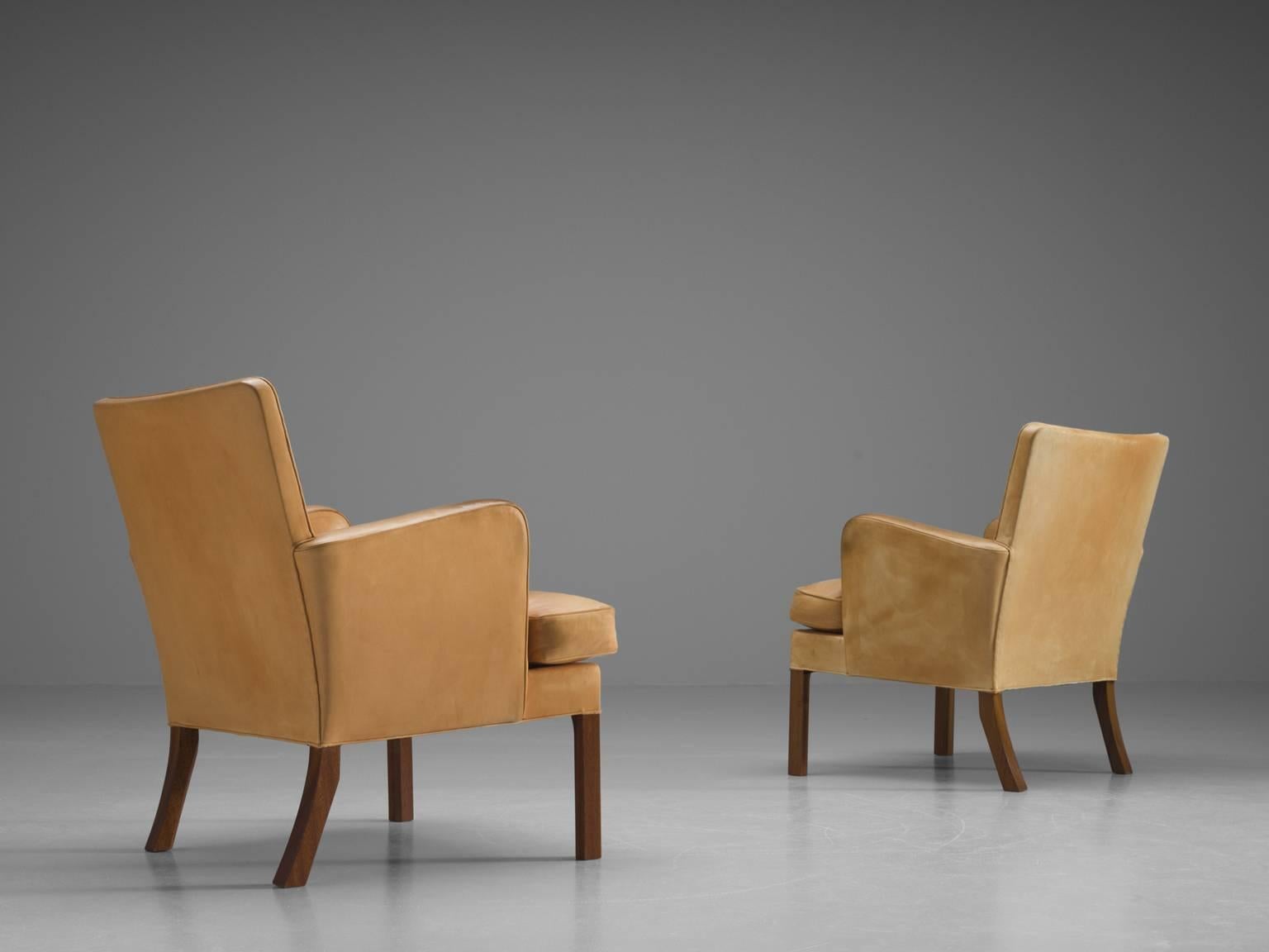 Easy chairs model 5313, cognac leather and mahogany, Kaare Klint for Rud. Rasmussen Snedkerier, Copenhagen, 1934.

This set of chairs are the archetypical easy chair as it may, simple, solid and comfortable. As anything from Klint, these chairs