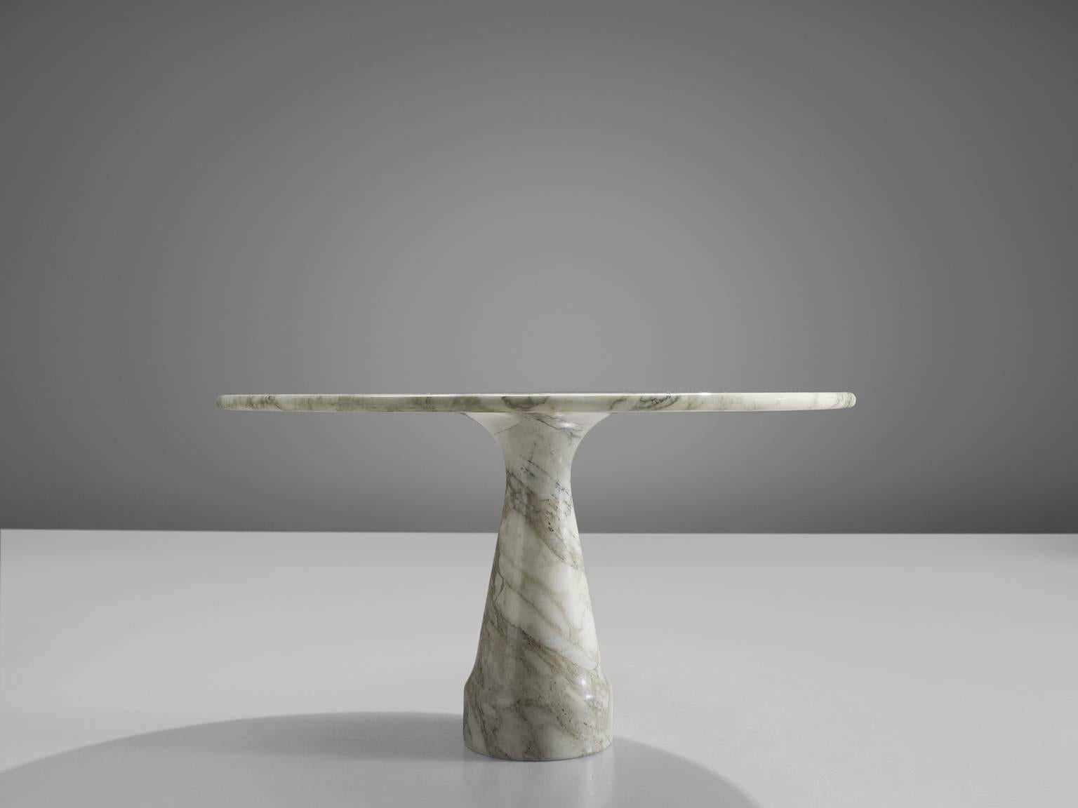 Dining table, marble, Italy, 1970s.

This marble shows wonderful grain vains and has a cone shaped base and a circular top. The circular top rests perfectly on the cone and they hold a perfect size ratio. The design showcases a play of balance and