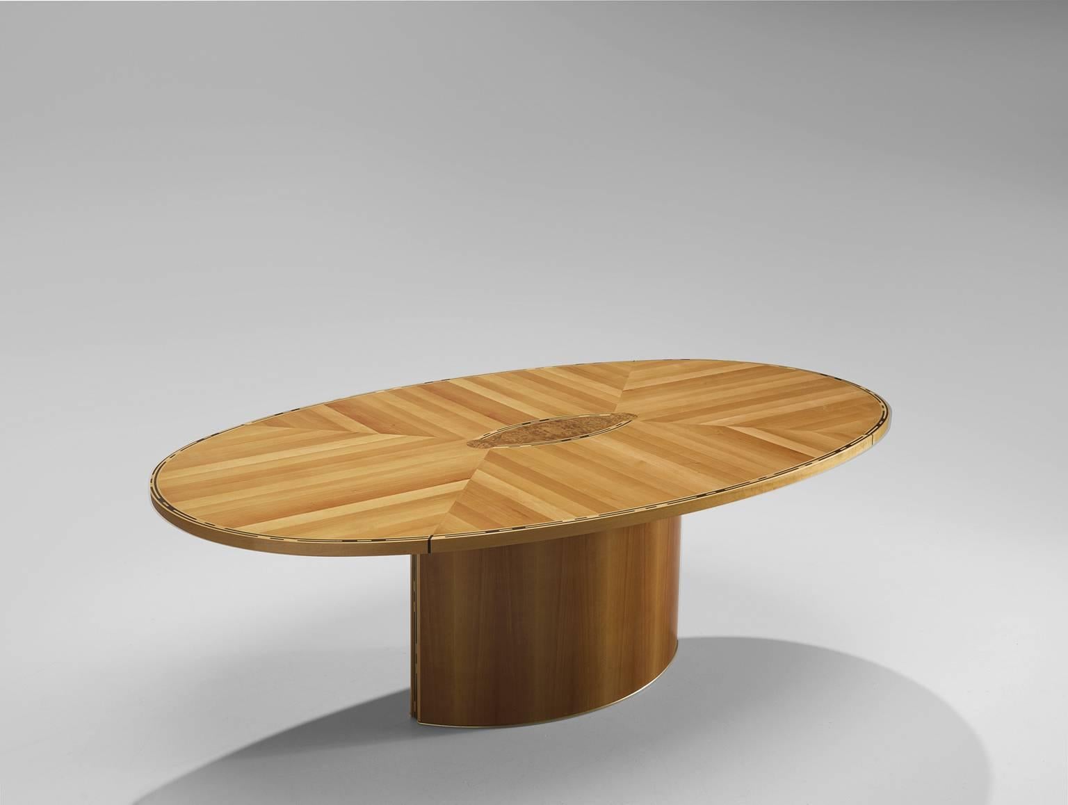 Centre table, wood and brass, Italy, 1980s.

This sculptural oval table is decorative and at the same time simplistic. The decorativeness is displayed in the top where the planks are laid out right-angled. Through this pattern a very lively, collage