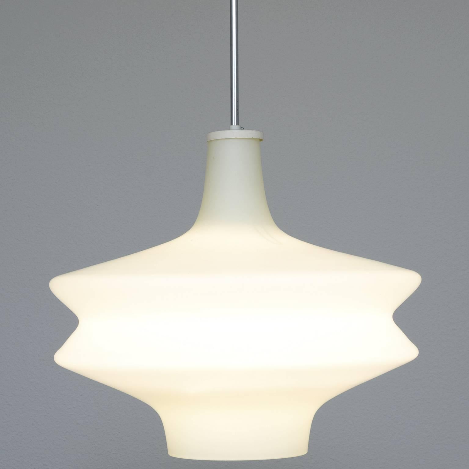 Pendant, opaline glass, metal, Europe, 1970s.

This lush, curvy shape is built up of two symmetrical tapered shapes that are connected at their wide end. The organic shapes combined with opaline glass results in a stunning soft light partition.