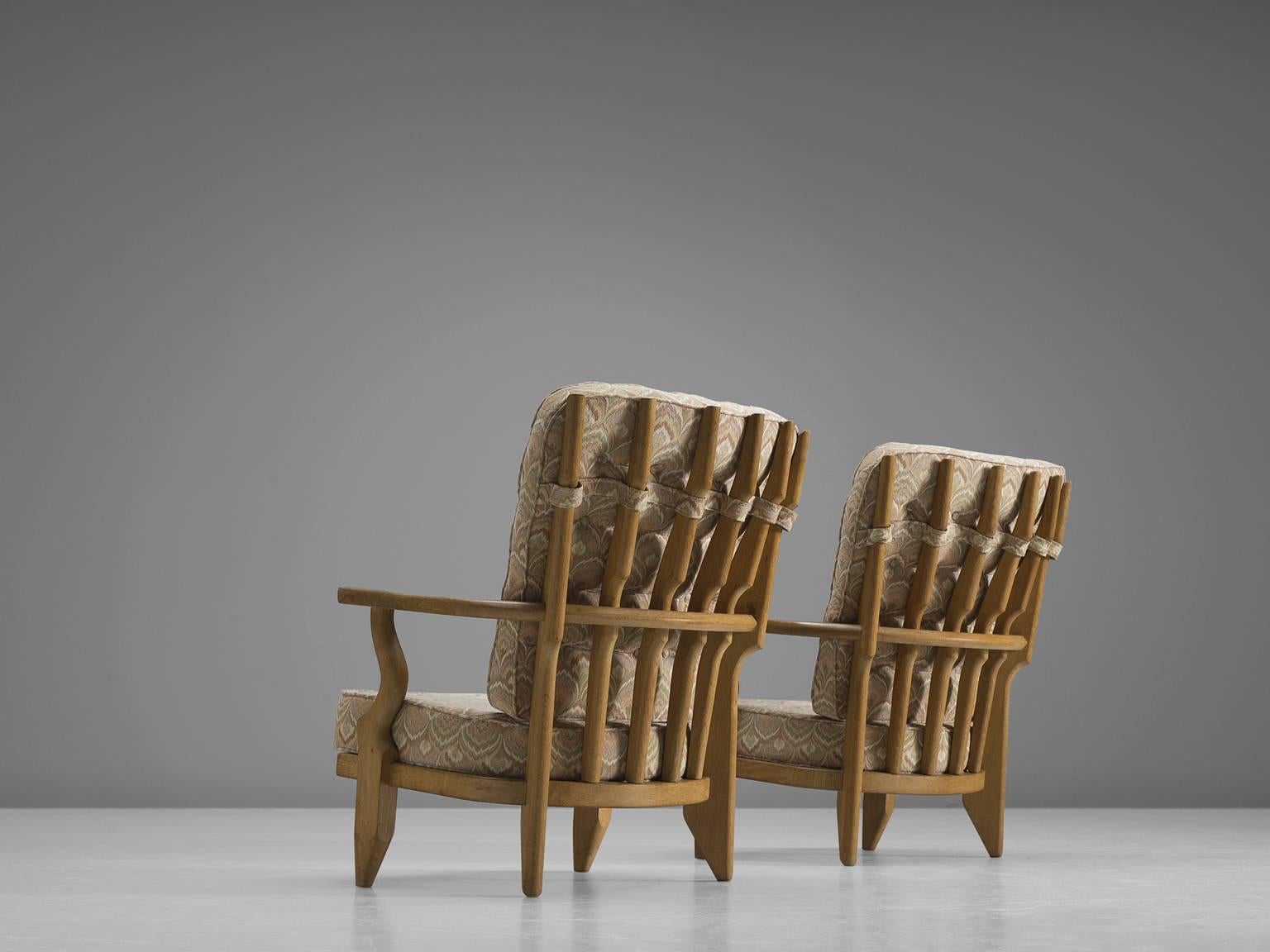 Lounge chairs oak, floral beige upholstery, oak, by Guillerme et Chambron, France, 1960s. 

Guillerme and Chambron are known for their high quality solid oak furniture, from which this is another great example. These chairs have an interesting,