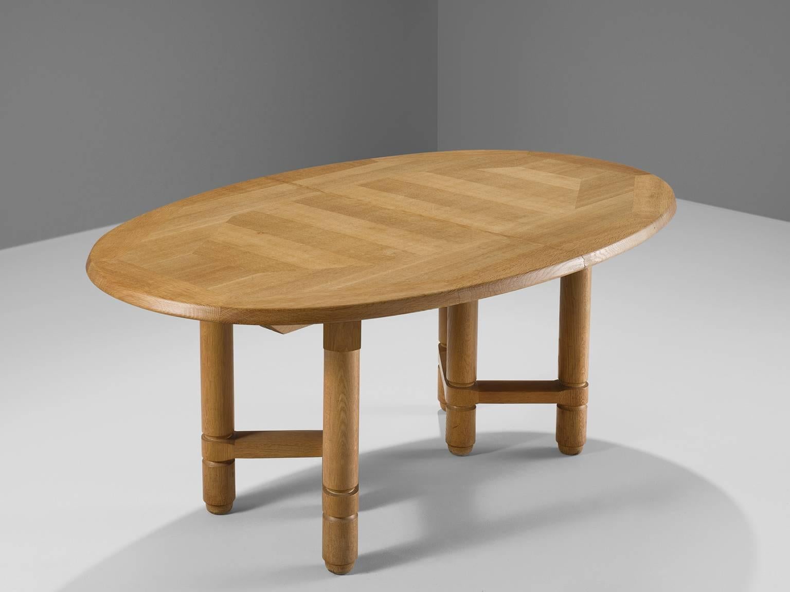 Dining table in oak, by Guillerme et Chambron for Votre Maison, France, 1960s.

Dining table in solid oak, with beautiful carved wooden decoration, designed by the French designer duo Guillerme and Chambron. The oval top features an inlay pattern.