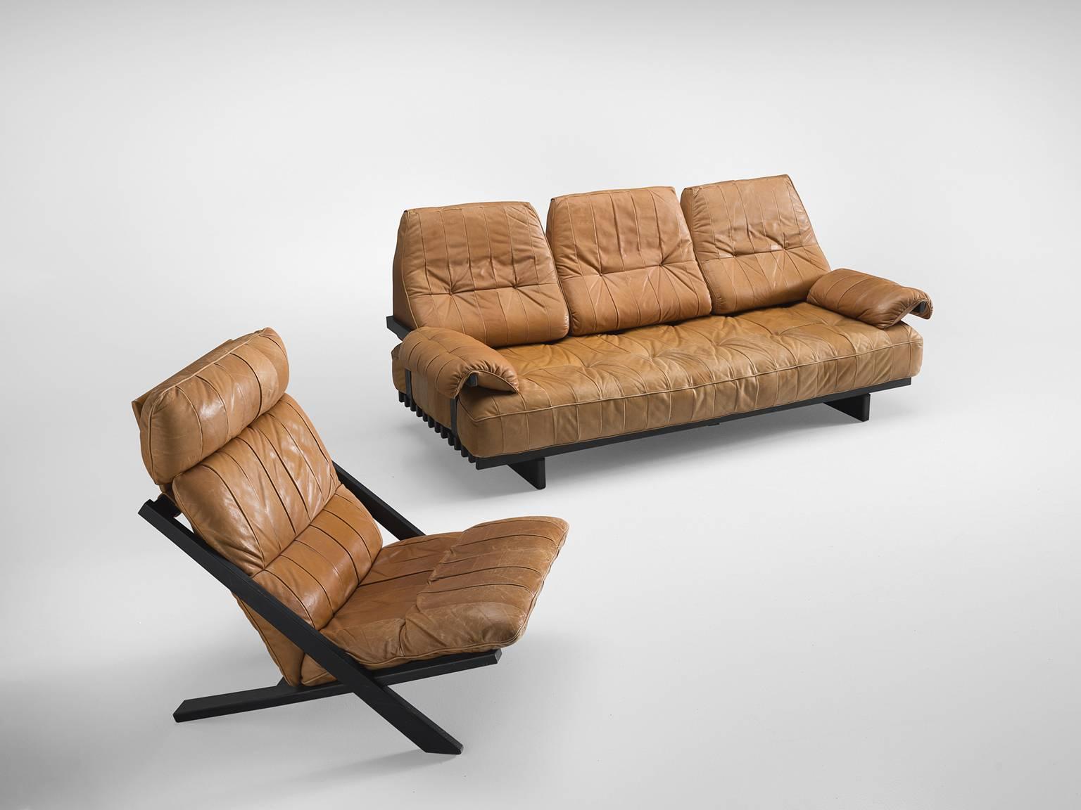 Ueli bergère for De Sede, lounge chair and sofa DS 80, in wood and cognac leather, Switzerland, 1970s.

High back lounge chair by de Swiss quality manufacturer De Sede. The X-shaped frame consists of black lacquered wood. This makes an interesting