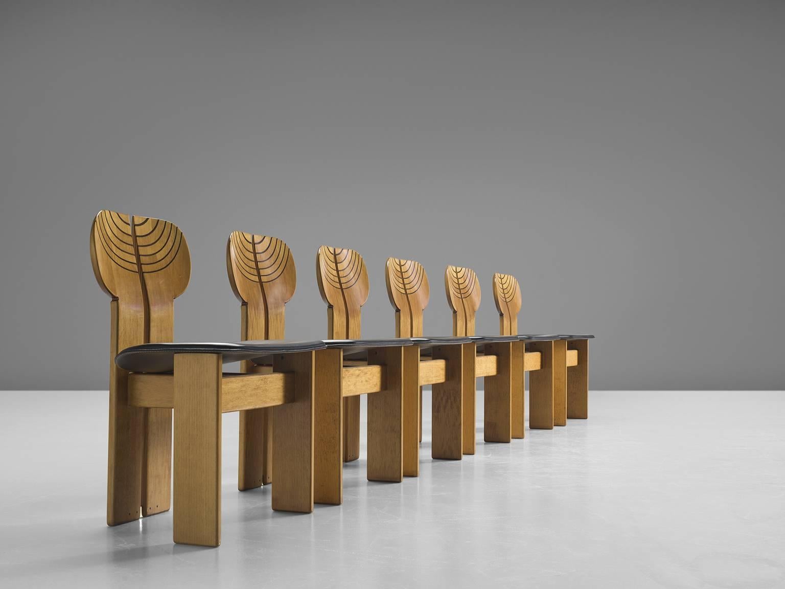 Six dining chairs by Afra & Tobia Scarpa in black leather, walnut, ebony and brass, Maxalto, Italy, 1975.

This set of chairs explicitly sculptural grand chairs are by Afra & Tobia Scarpa and are titled 'Africa' and are part of the Artona