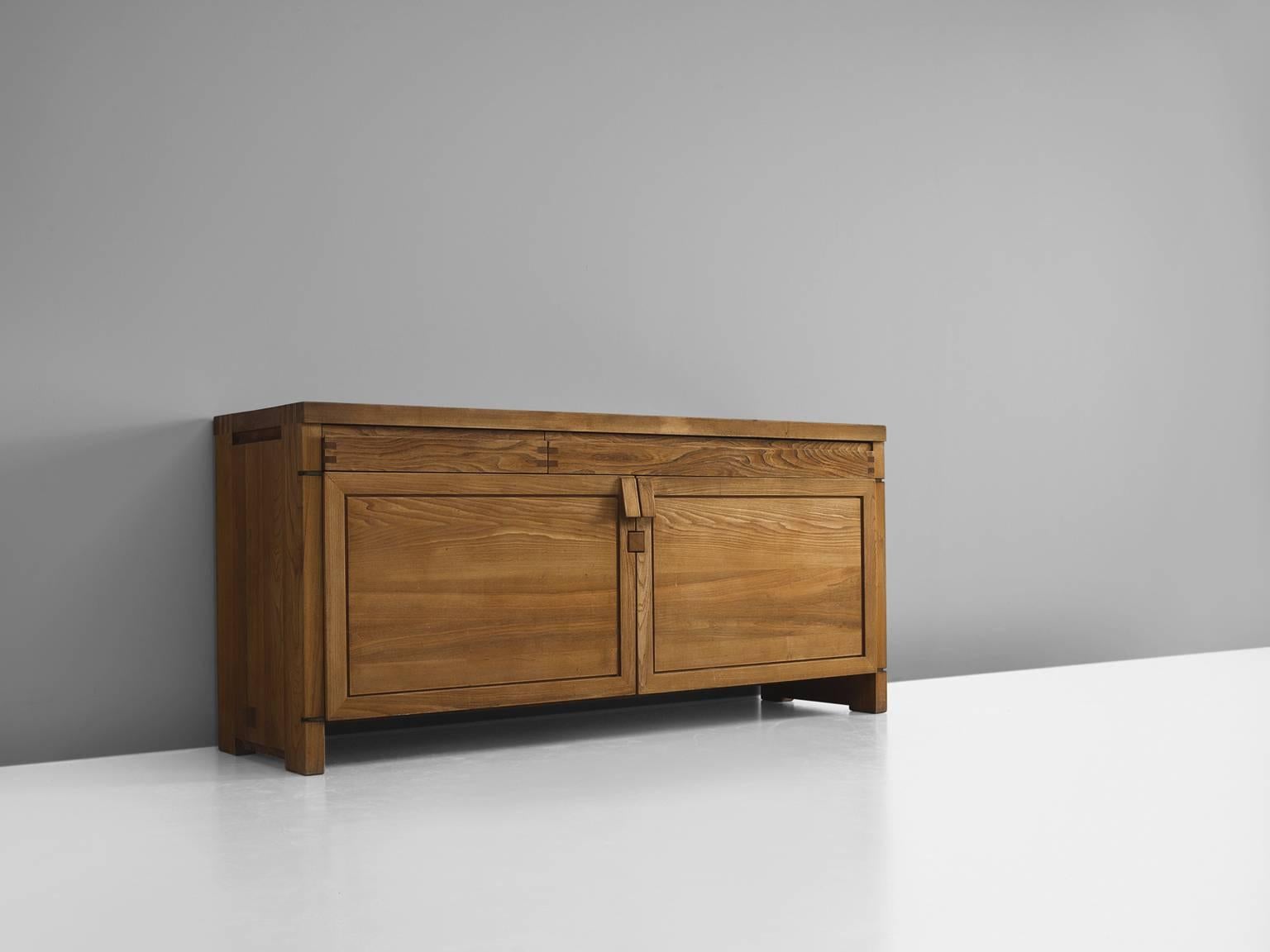 Pierre Chapo, sideboard, Model R08, elm, France, ca. 1964.

This exquisitely crafted credenza combines a simplified yet complex design combined with nifty, solid construction details that characterize Chapo's work. The well proportioned doors and