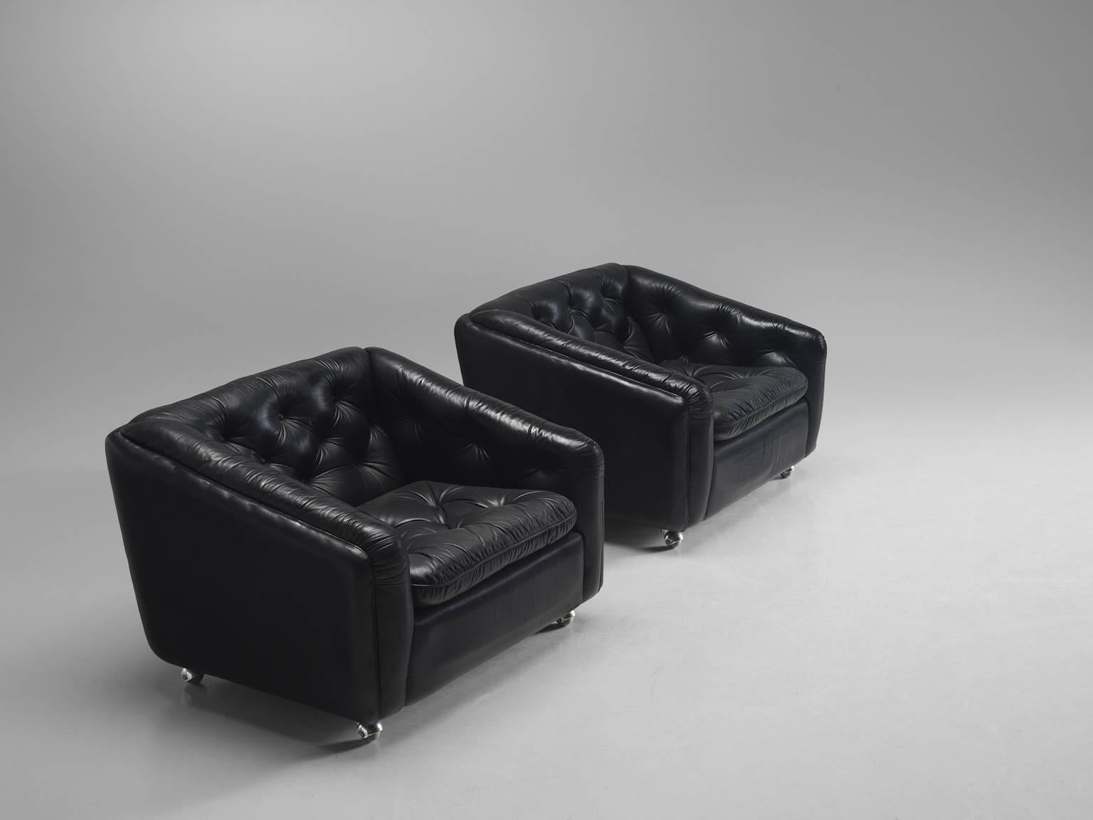 Lounge chairs C610 in black leather and steel by Geoffrey Harcourt for Artifort, the Netherlands, 1960s. 

These tufted comfortable chairs feature functional steel wheels. The combination of steel and the black faux leather upholstery gives this set