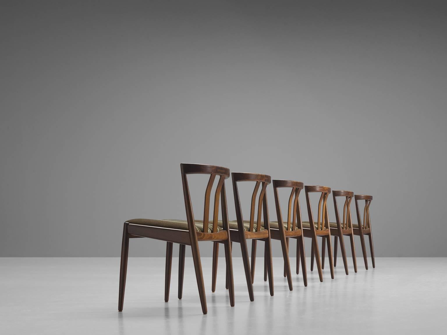 Six chairs, teak and wool, Denmark, 1960s

Elegant set of six Danish dining chairs with open back with two slats, diagonal back legs that run all the way through to the back rest. This set is playful and dynamic yet also bears traits of classic
