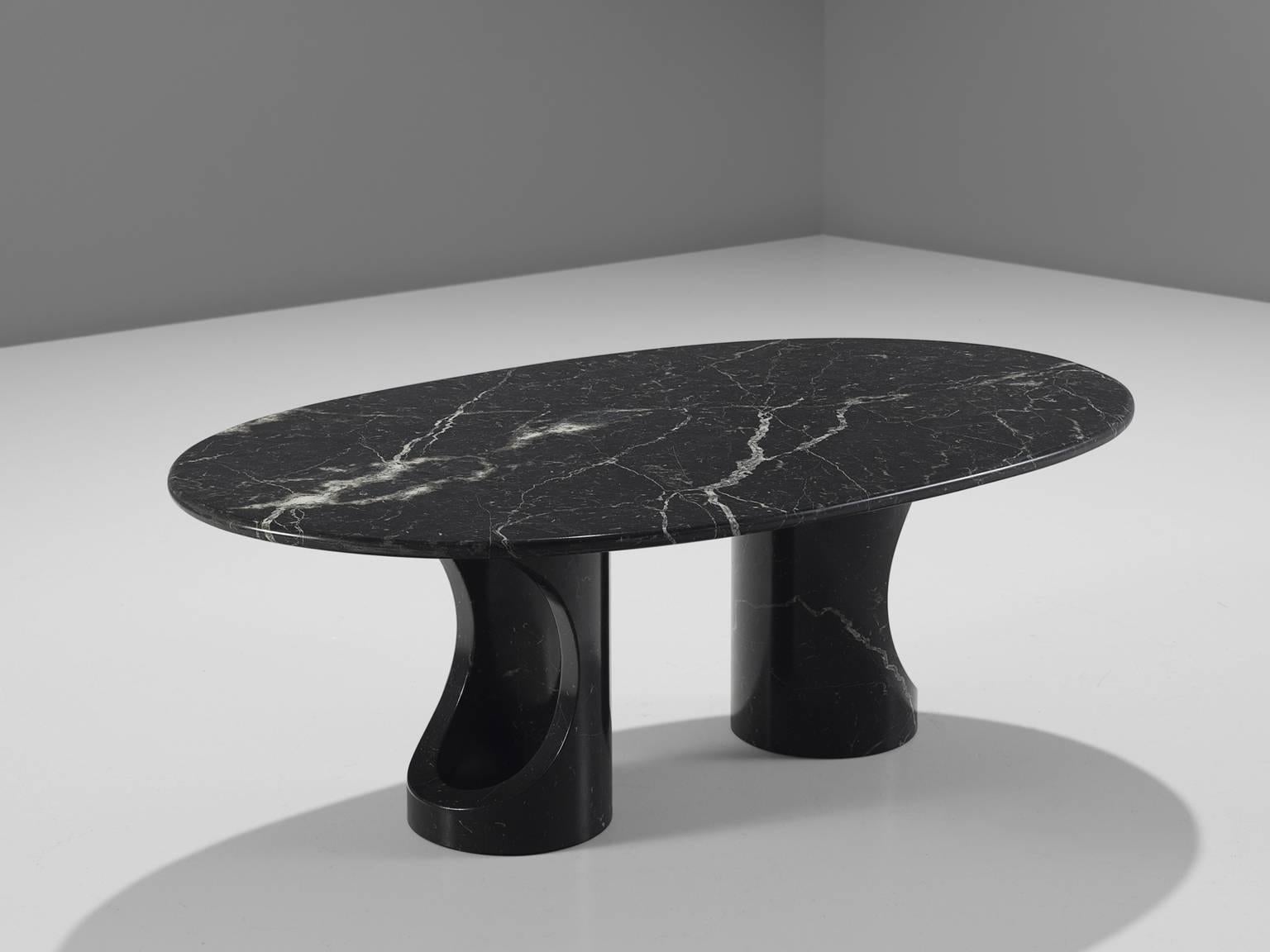 Cocktail table, marble, Italy, 1970s. 

This sculptural table is a skillful example of postmodern design. The oval table features no joints or clamps and is architectural in its structure. The table is supported by two separate, mirrored dented