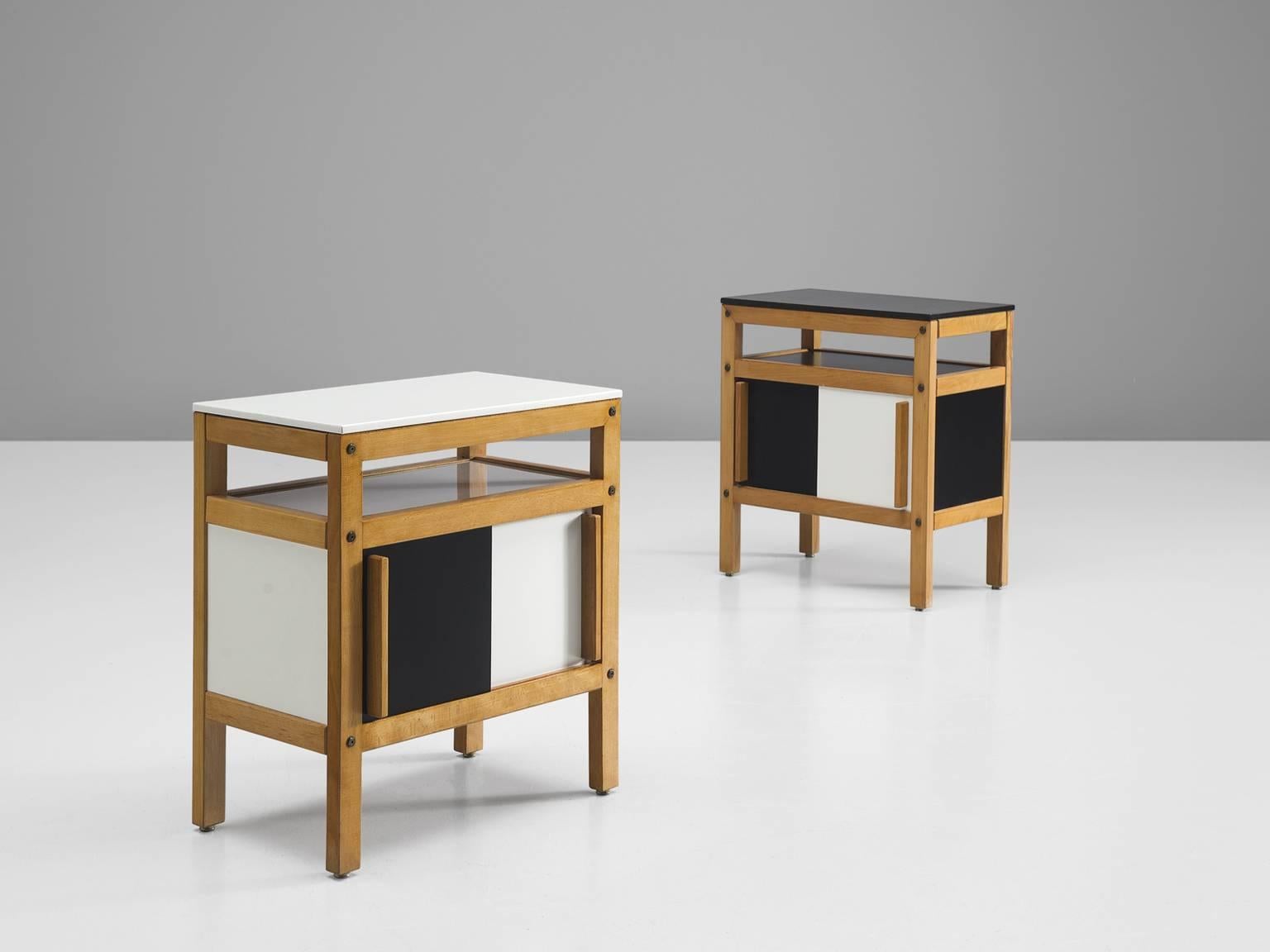 Nightstands, veneer, plywood, wood, in black and white, France, 1950s

These two end tables are archetypical for the geometric, robust and clean designs of Andre Sornay. The tables feature four sturdy legs, sliding black and white doors, an open