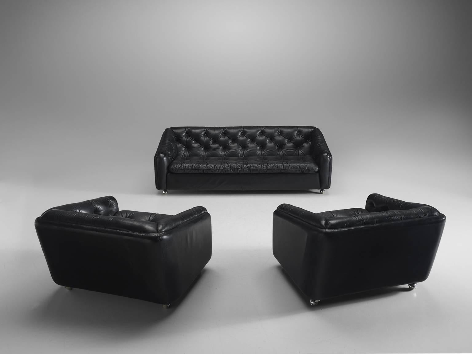 Lounge chairs and sofa C610 in black leather and steel by Geoffrey Harcourt for Artifort, the Netherlands, 1960s. 

These tufted comfortable chairs and sofa feature functional steel wheels. The combination of steel and the black faux leather