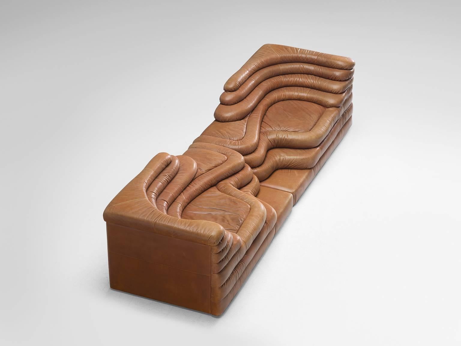 Pair of DS1025 'Terrazza' landscape elements, in cognac leather, by Ubald Klug for De Sede, Switzerland, 1970s. 

Waterfall shaped sofa in cognac leather by the Swiss manufacturer De Sede. The leather is in outstandingly good patinated condition.