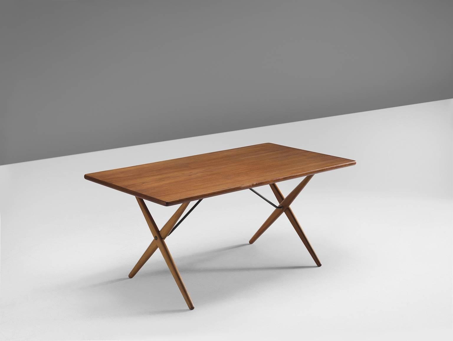 Table model AT-303, in teak, oak and metal, by Hans J. Wegner for Andreas Tuck, Denmark, 1955.

Dining table with elegant X-shaped legs, by Danish Designer Hans Wegner. This table is considered as one of the best known designs from Wenger. From a