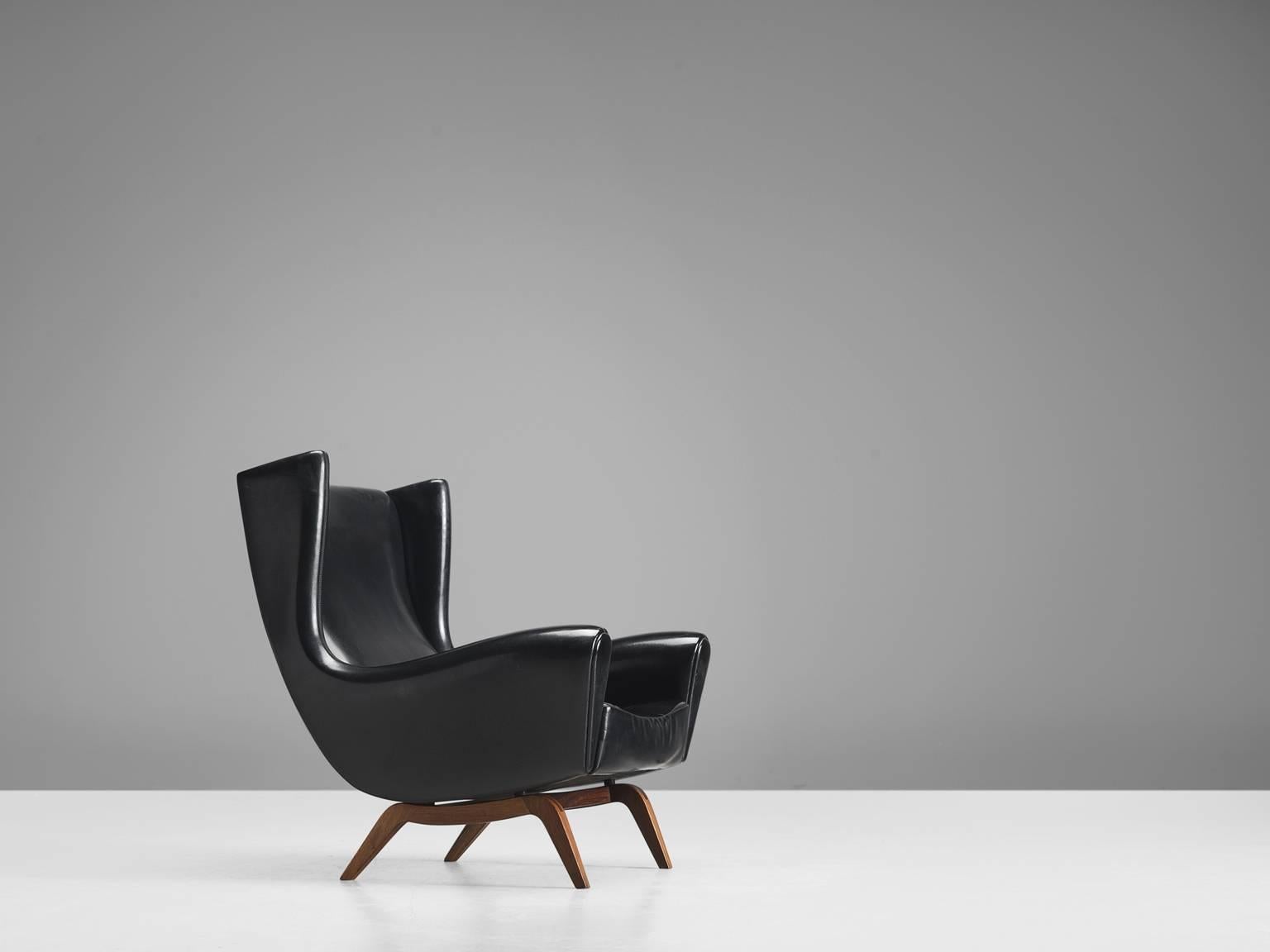 Lounge chair 'Model 110', in teak and black faux leather by Illum Wikkelsø for Søren Willadsen, Denmark, 1950s.

This well-designed armchair shows an unusual elegance and great eye for detail, combined with outstanding craftsmanship, which is