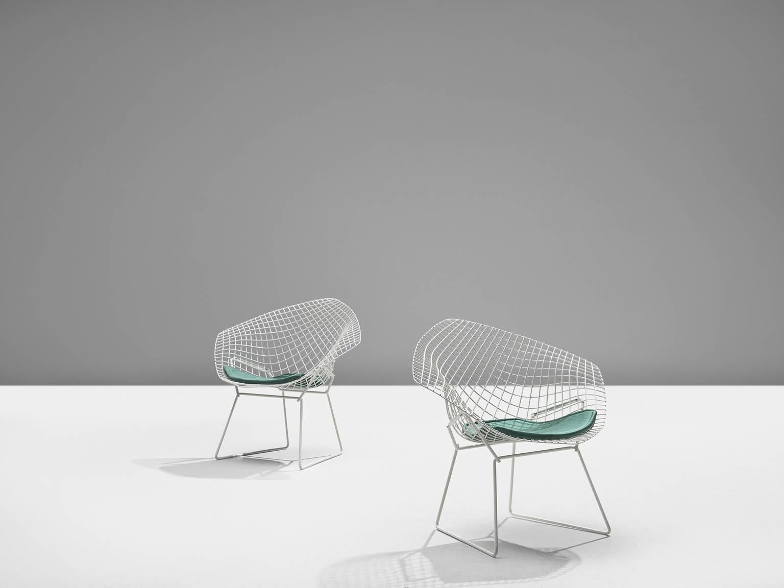Pair of 'Diamond' chairs by Harry Bertoia for Knoll, white coated metal, turquoise cushion, 1950s (later production)

The Diamond Chair is, according to Knoll, an astounding study in space, form and function by one of the master sculptors of the
