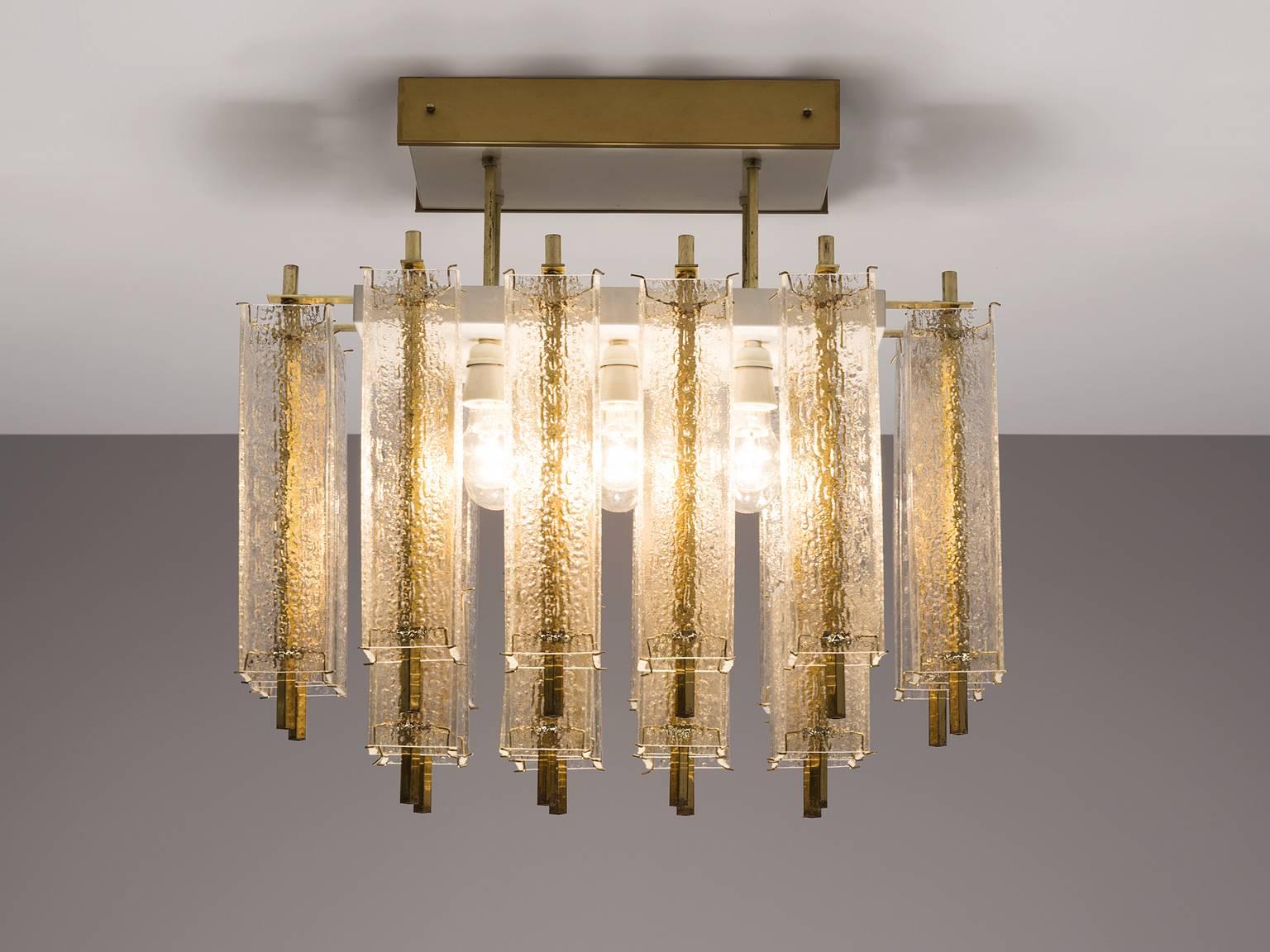 Chandelier, in glass and brass, Europe, 1970s. 

This elegant square chandelier features a great amount of rectangular structured glass shades and a rectangular brass fixture. The frame is made of brass and holds four brass pipes that have