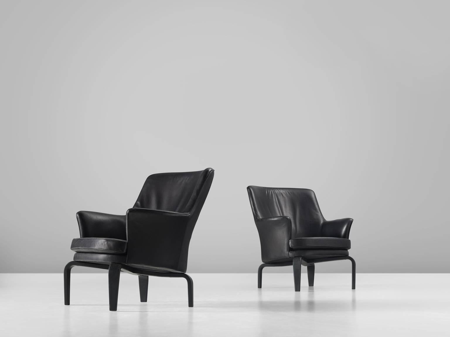 Arne Norell for Norell mobilier, 'Pilot T184' armchairs with leather and stained beech, Sweden, 1970s. 

This set of high back chairs are slightly curved and have a high headrest. They are upholstered entirely with very high quality aniline black
