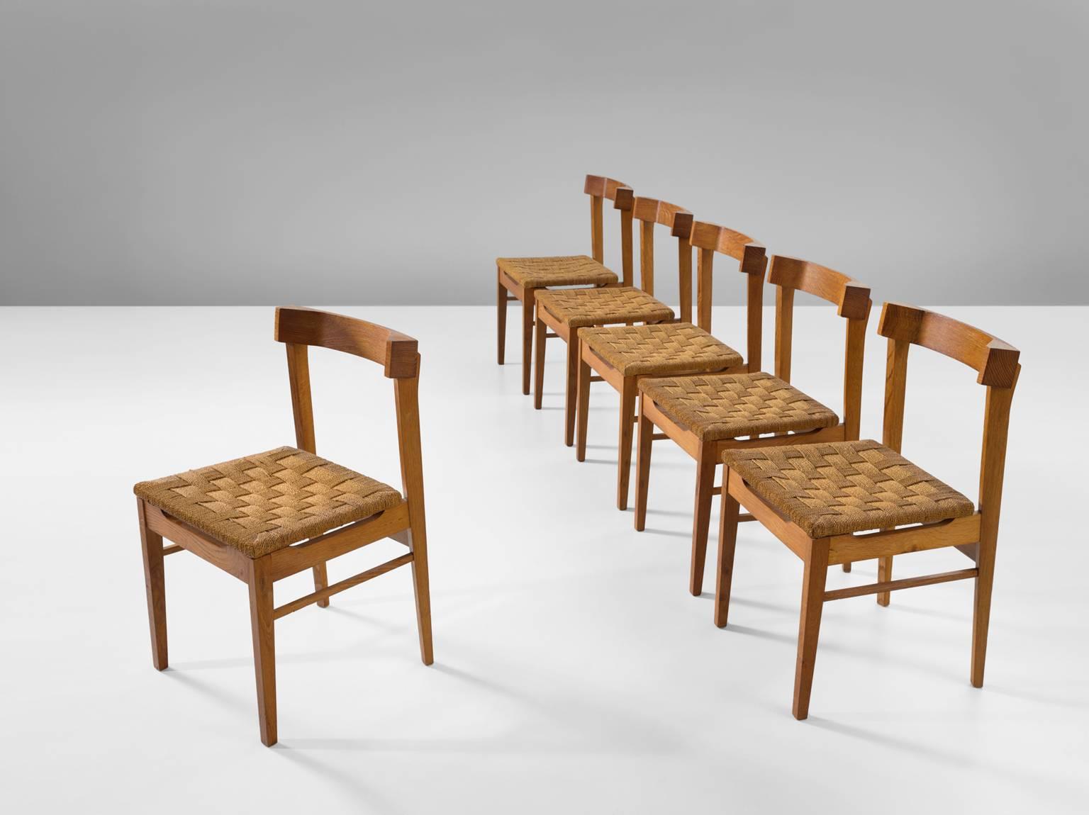 Six chairs, oak and rope, The Netherlands, 1960.

These six chairs are executed in rope and wonderfully aged oak. The chairs have a very solid and geometric backrest. The chairs are both functional and clear in their design, as is common of most