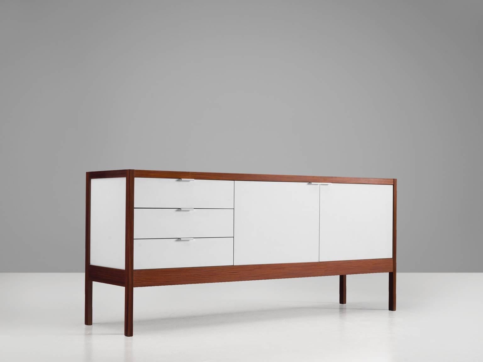 Dieter Waeckerlin for Idealheim, white formica, rosewood, Switzerland, design 1963, later production

This sideboard is designed by Dieter Waeckerlin for Idealheim and was produced in small numbers only. The credenza features clean lines and a