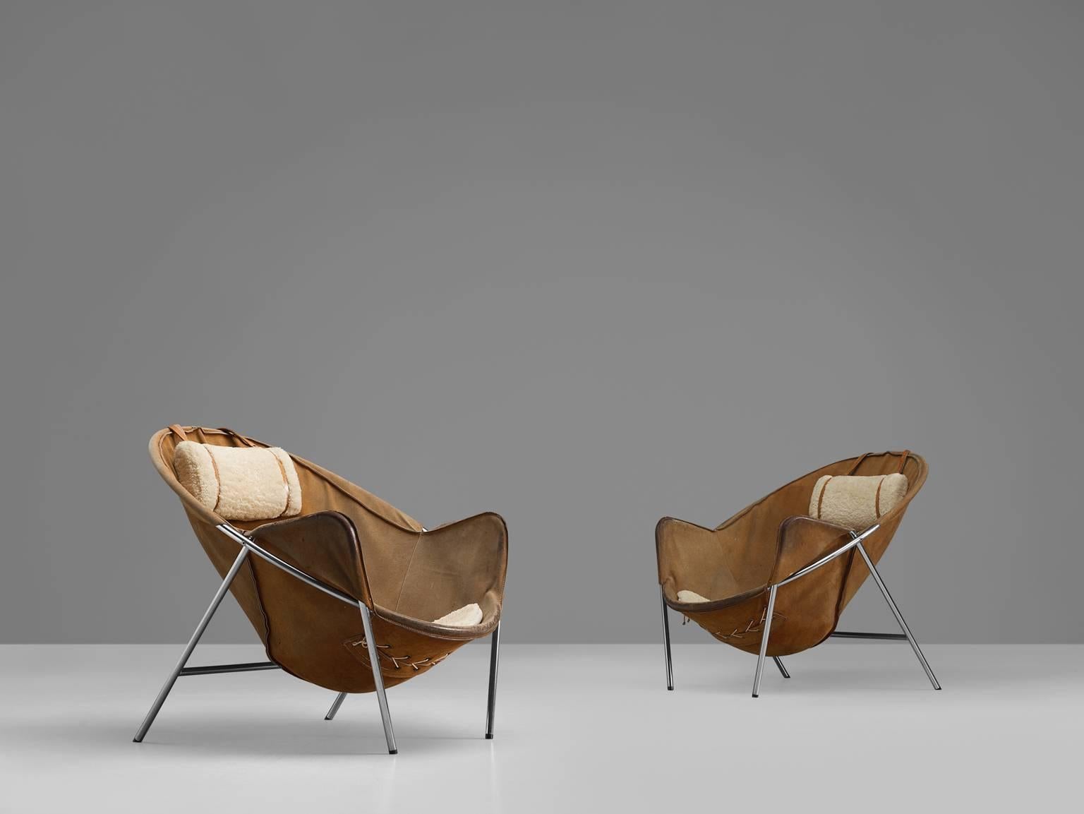 Lounge chairs, in metal, suede, fabric and wood, by Erik Ole Jorgensen for Olaf Black, Denmark, 1953. 

This set of two easy chairs is executed in beige to cognac suede. These sling chairs consist of a chromed tubular frame. To increase the comfort