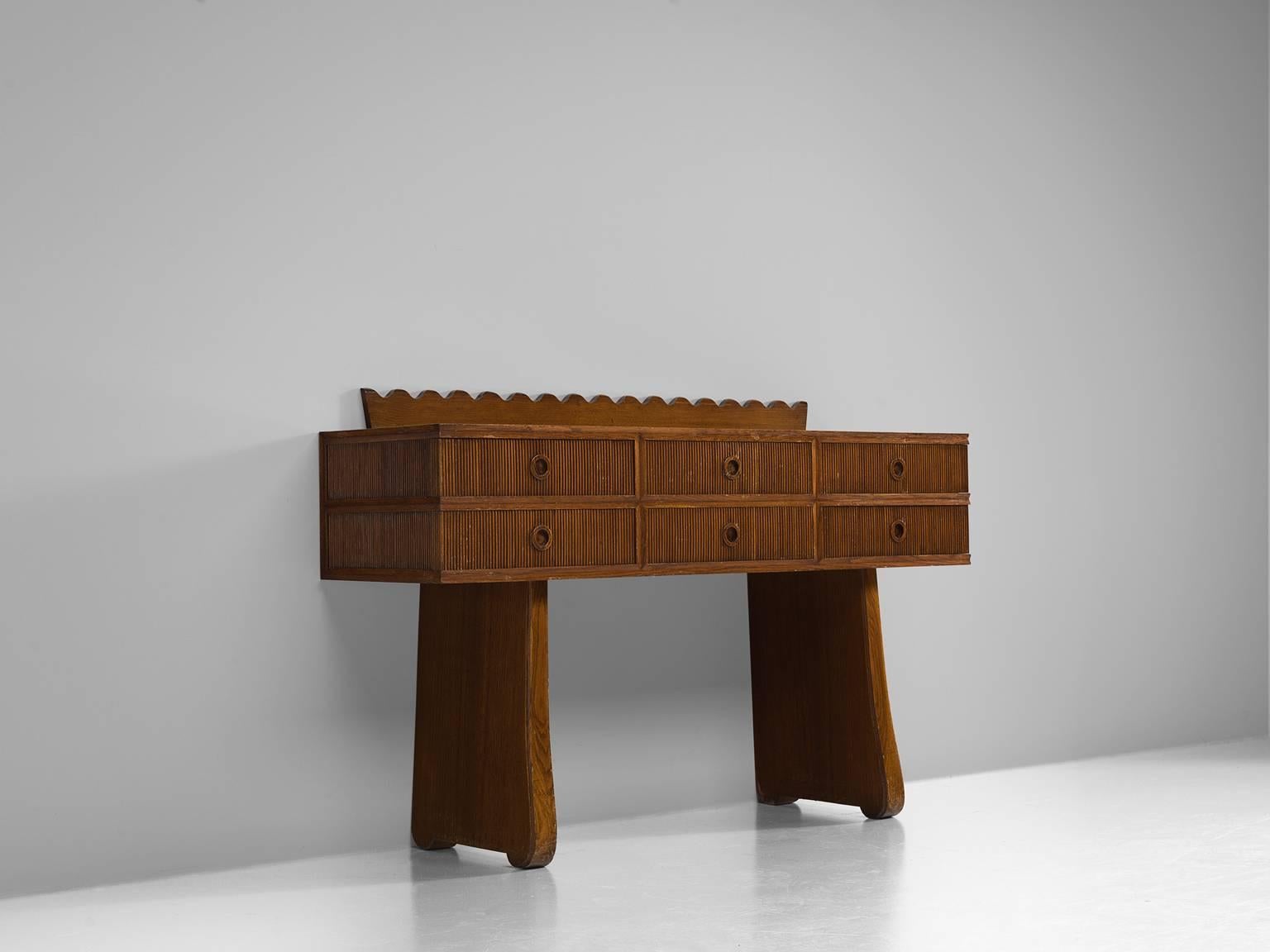 Sideboard, Italian walnut, Italy, 1940s.

Delicate and playful Italian cabinet unit in the style of Paolo Buffa on high, broad legs that support the chest with six drawers. The round handles are made of circular, carved handles. The back features