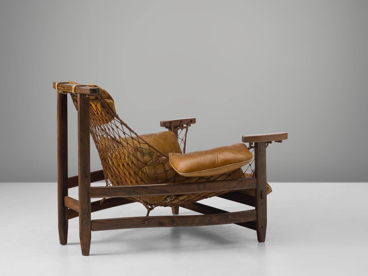 Jean Gillon, 'Jangada' armchair and ottoman, rosewood, nylon rope, original leather, Brazil, 1968.

This robust and hefty armchair is designed by Jean Gillon. The originality of this Janganda comes from the concept of the body being captured by