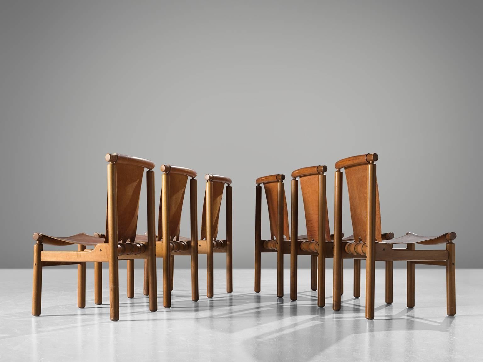 Dining chairs attributed to Ilmari Tapiovaara, wood and leather, Finland, 1950s.

These robust chairs feature a geometric, sturdy frame. Yet they feature a certain spaciousness thanks to the decorative opening on the bottom of the backrest. The