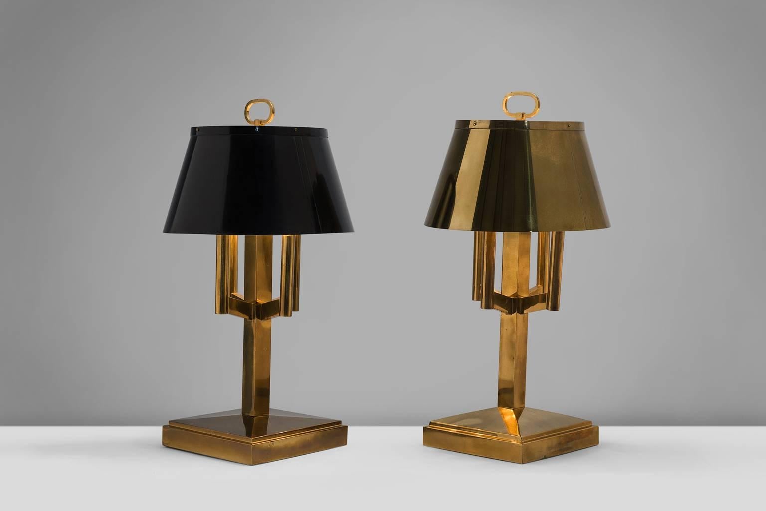 Table lights, brass, Italy, 1940s.

These strong and sturdy table lamps bear strong traits of the Classic shaded desk light. Yet the shades are combined with an strong, angular bases, giving them a modern aesthetic. These lamps have, due to time and