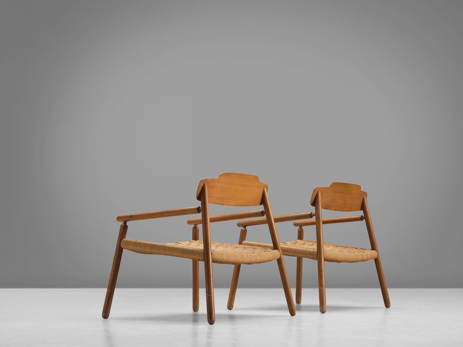 Lounge chairs, wood and rope, Finland, 1950s.

These wide, grand armchairs are executed in wood and with a rattan seat are very spacious. Thanks to their wide appearance they stand solid. The legs are placed diagonal and are made from solid wood.
