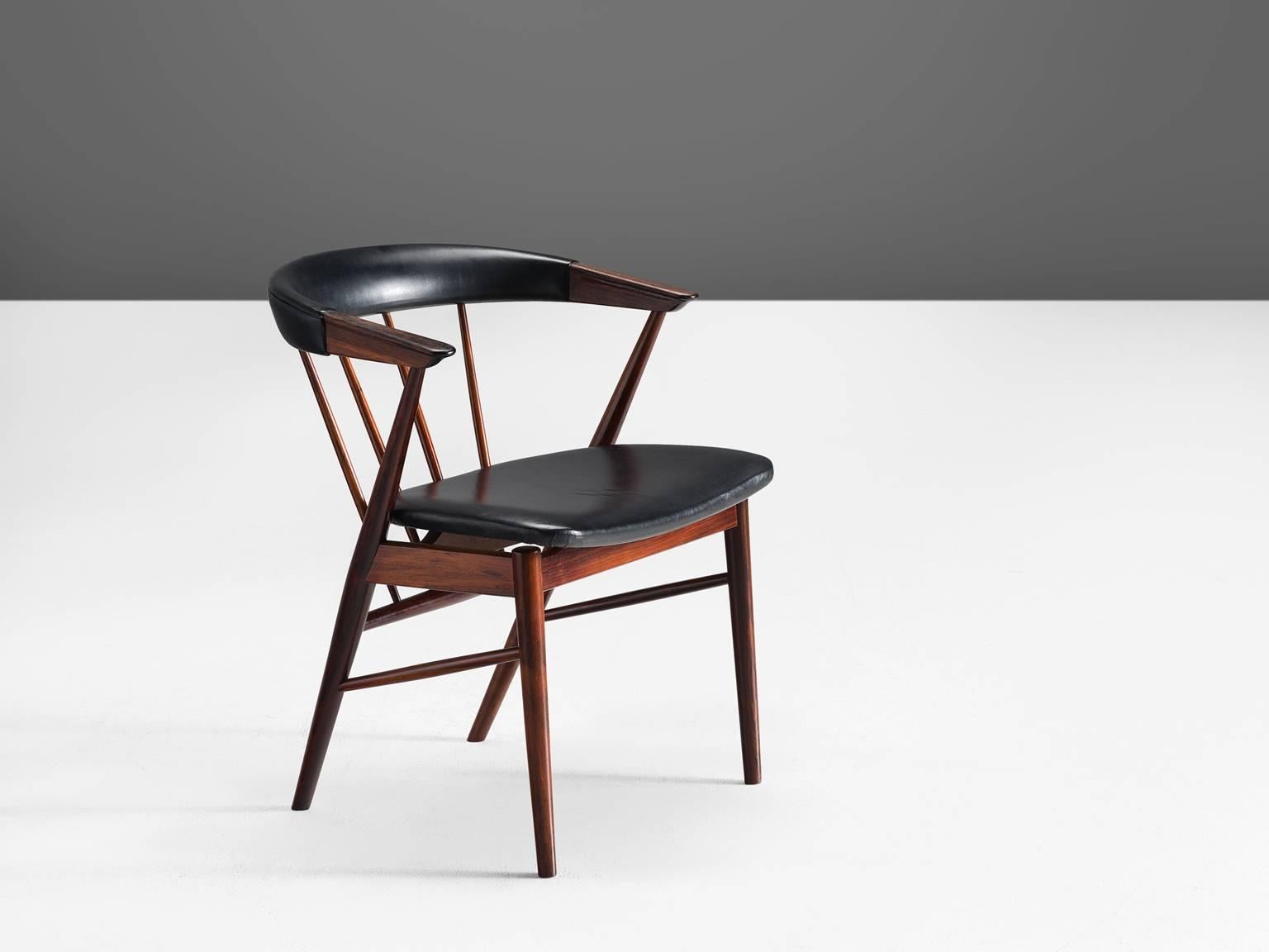 Helge Sibast, chair, rosewood and leather, Denmark, 1950s.

This chair by Helge Sibast for Sibast Furniture exhibits a distinct cantilevered seat with a bent backrest. The back is supported with a series of tapered spindles. The back legs taper into