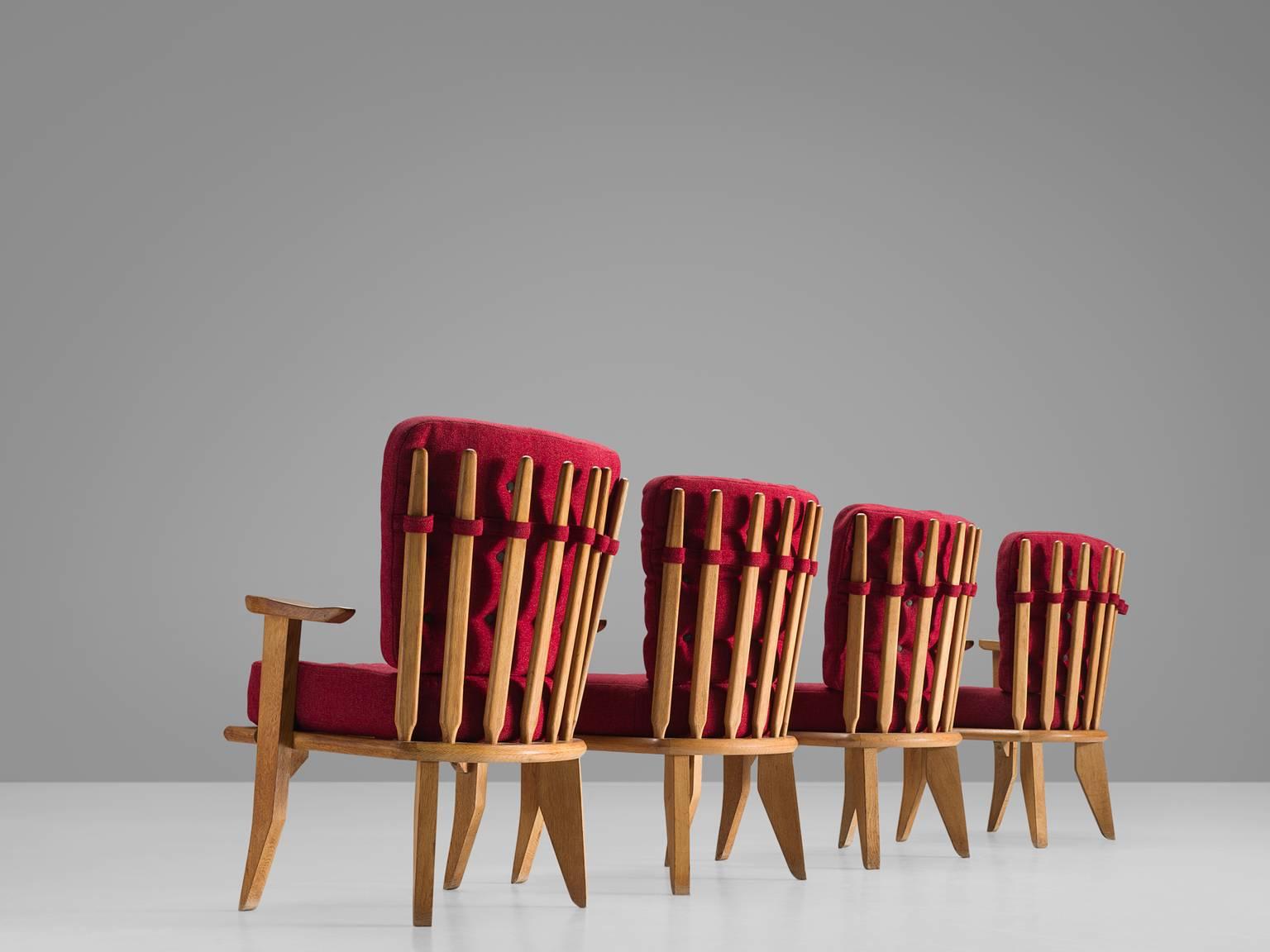 Jacques Chambron and Robert Guillerme, easy chairs, red fabric, oak, France, 1950s.

These sculptural easy chairs are designed by the designer duo Guillerme and Chambron. The couple is known for their high quality solid oak furniture. These robust