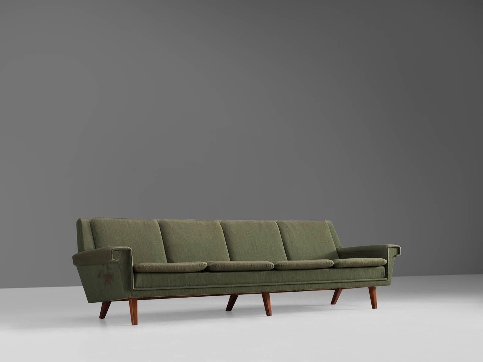 Four-seat sofa, green, wood, Denmark, 1950s

This sofa holds the middle between theatrical details that are used on a minimalistic base. The tapered wooden legs are accompanied by a neutral green colored thick fabric that functions as a modest