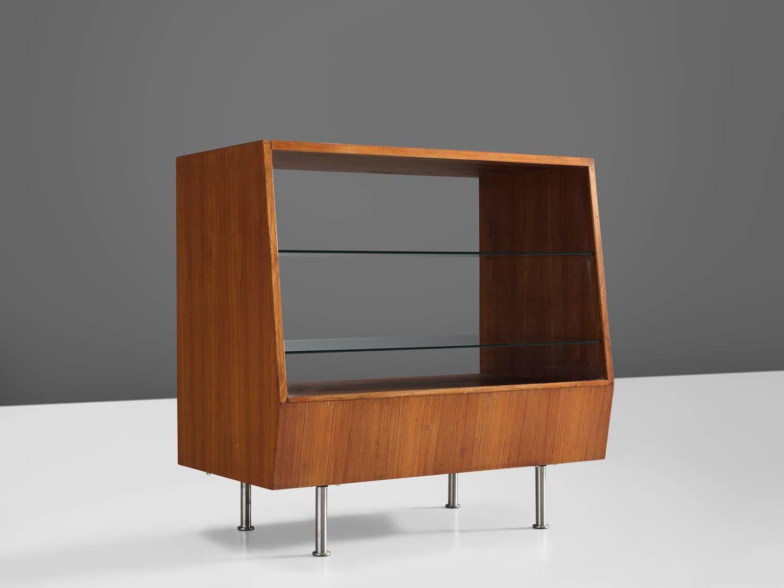 Vitrine, wood, steel, Denmark, 1960s.

Elegant and geometric showcase in teak. The front features a slight triangle when seen from the side, resulting in a large bottom shelf. The base of this vitrine is beautifully simply designed by means of four
