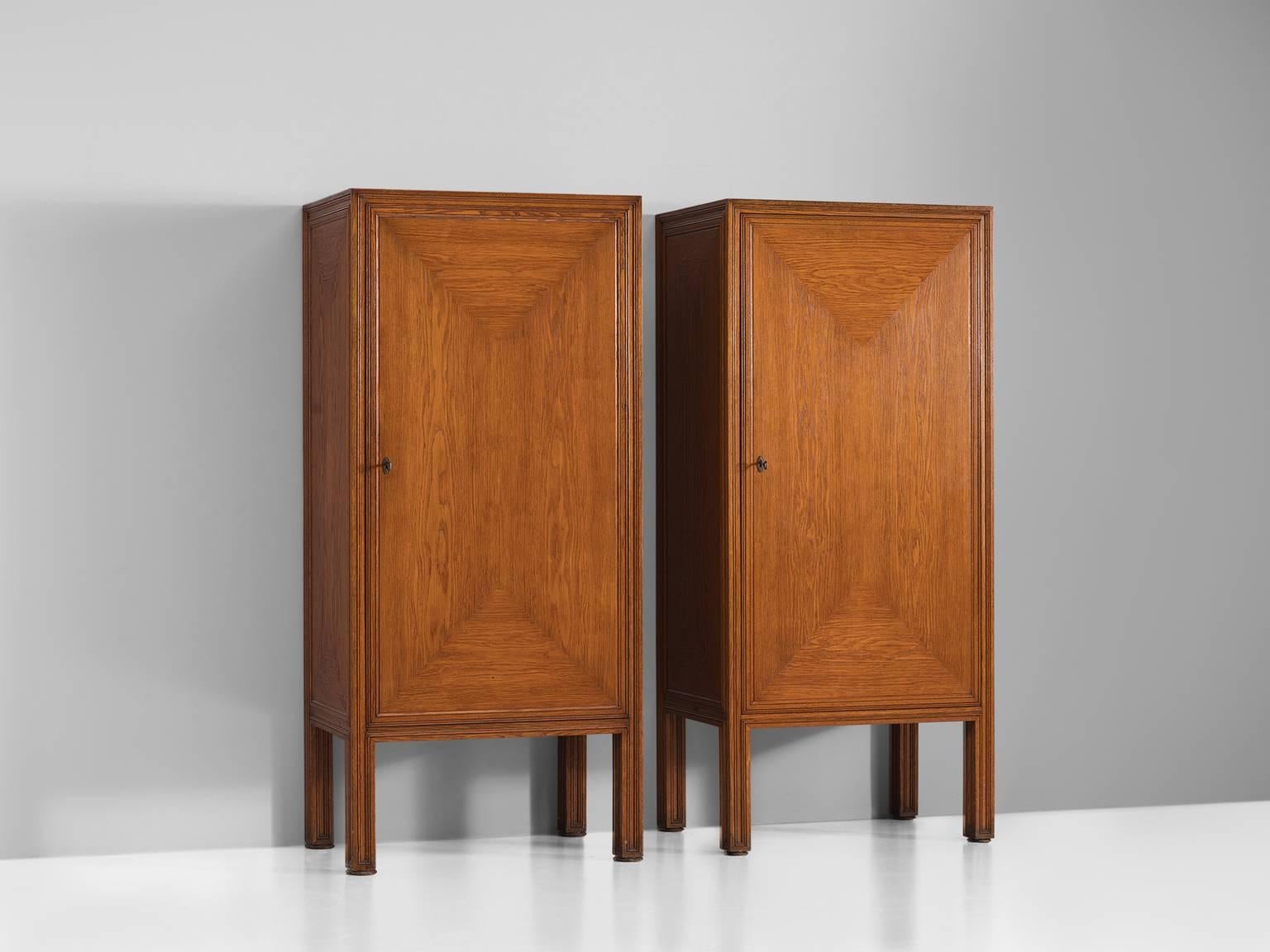 Danish cabinet maker, high cabinets, stained oak, Denmark, 1960s.

These elegant high cabinets are wonderfully executed and seem to have traits of the level of Rud Rasmussen. The grain of the wood is bookmatched and used to create and abstract,