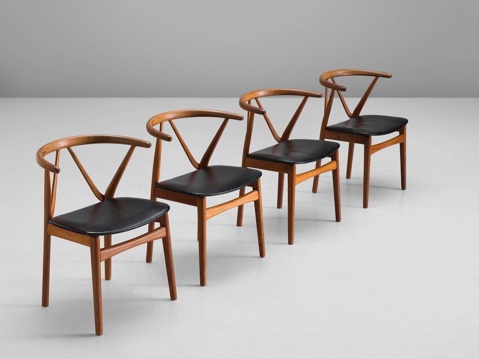 Set of four dining chairs model 255, in teak and faux-leather by Henning Kjaernulf for Bruno Hansen, Denmark, 1950s. 

Set of four elegant dining chairs with strong resemblance to the designs of Hans Wegner. These solid teak chairs have a beautiful