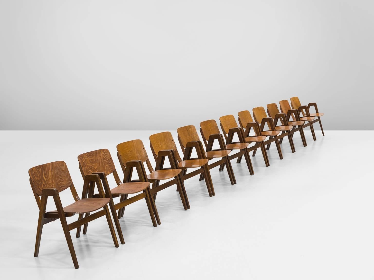 Thonet, set of twelve armchairs, in beech, 1960s.

Set of twelve bended plywood armchairs in a warm patinated beech. These chairs were designed by for the famous bentwood manufacturer Thonet. The most interesting detail in these chairs is the