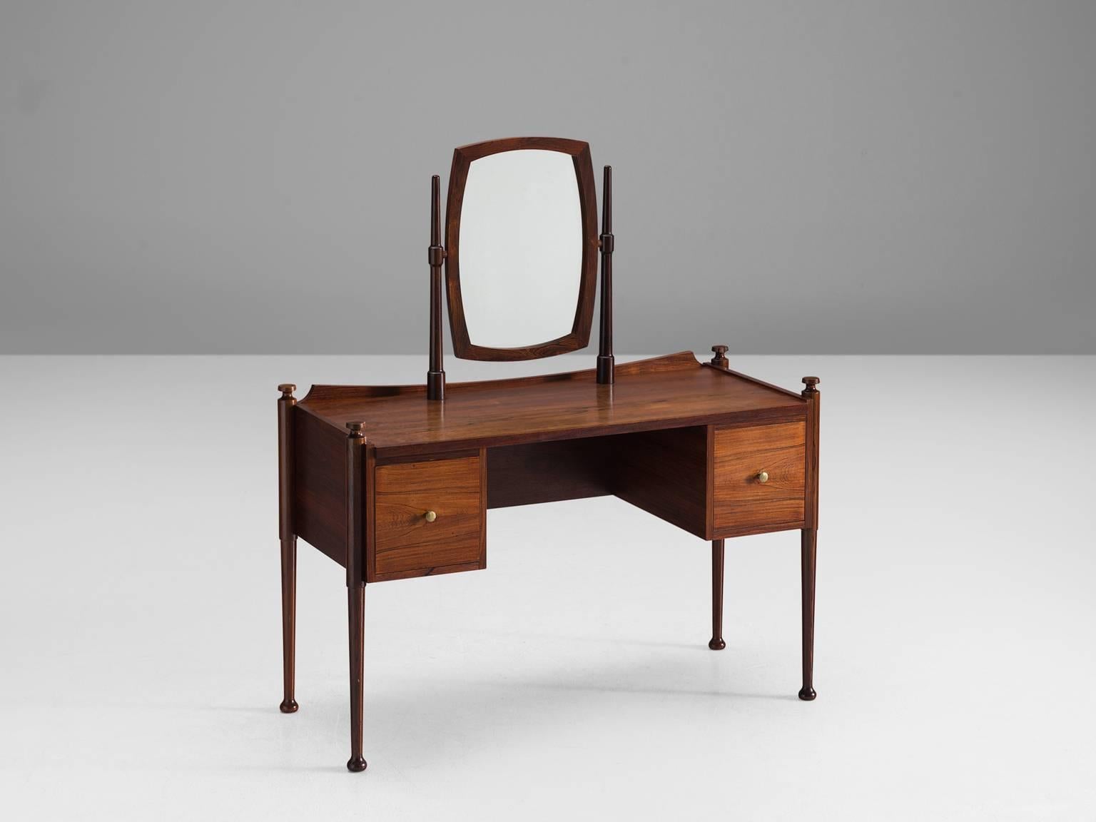 Dressing table, rosewood, brass, Denmark, 1950s.

This delicate little vanity table shows many refined details such as the finished back. The drawers on the front, each featuring a small brass knob, have a book matched rosewood front. The four