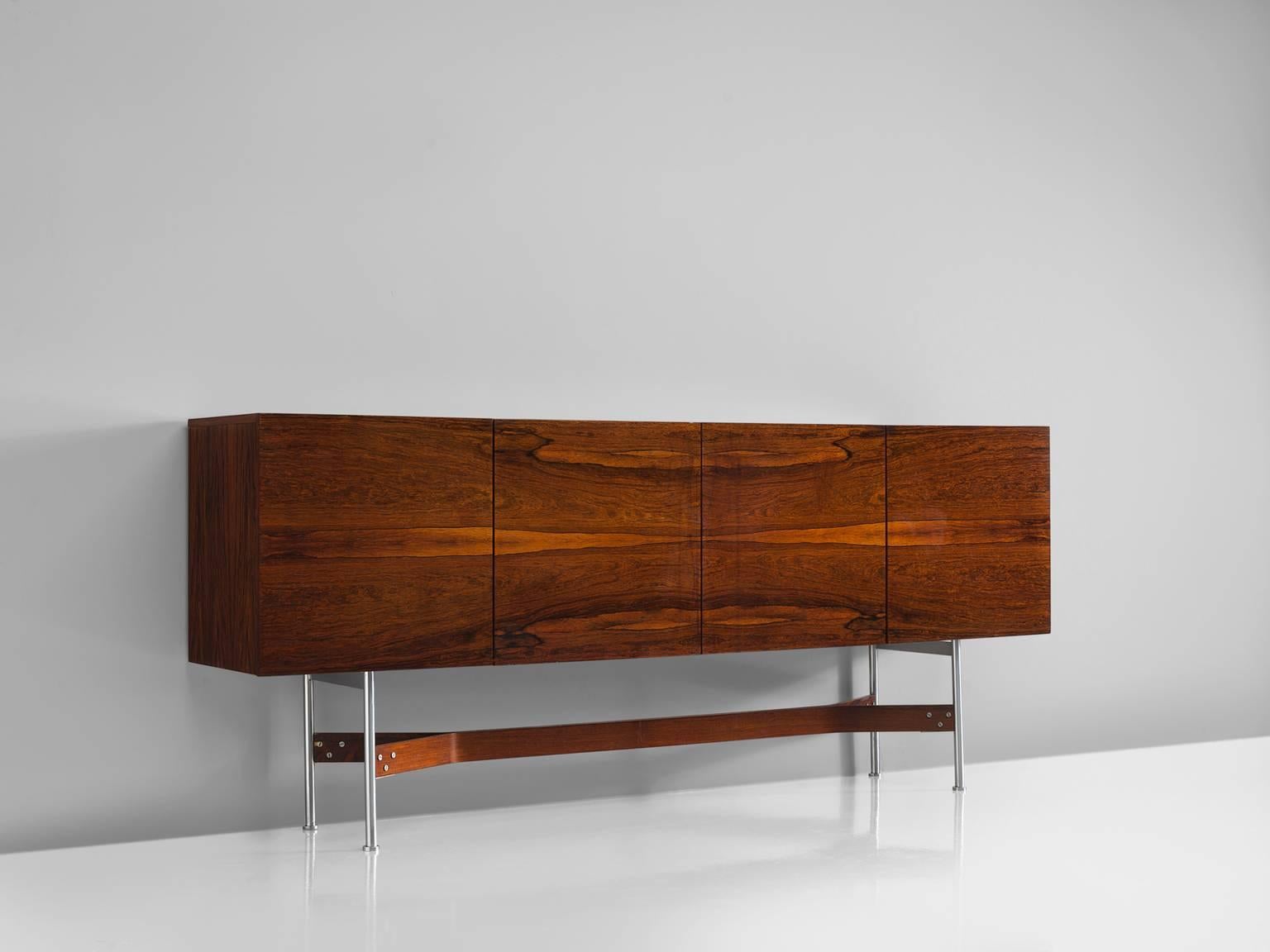 Sideboard, in rosewood and metal by Rudolf Bernd Glatzel for Fristho Franeker, the Netherlands, 1962. 

This high board is designed by Rudolf Bernd Glatzel for Fristho. The sideboard shows refined crafted details with a bookmatched front. One of