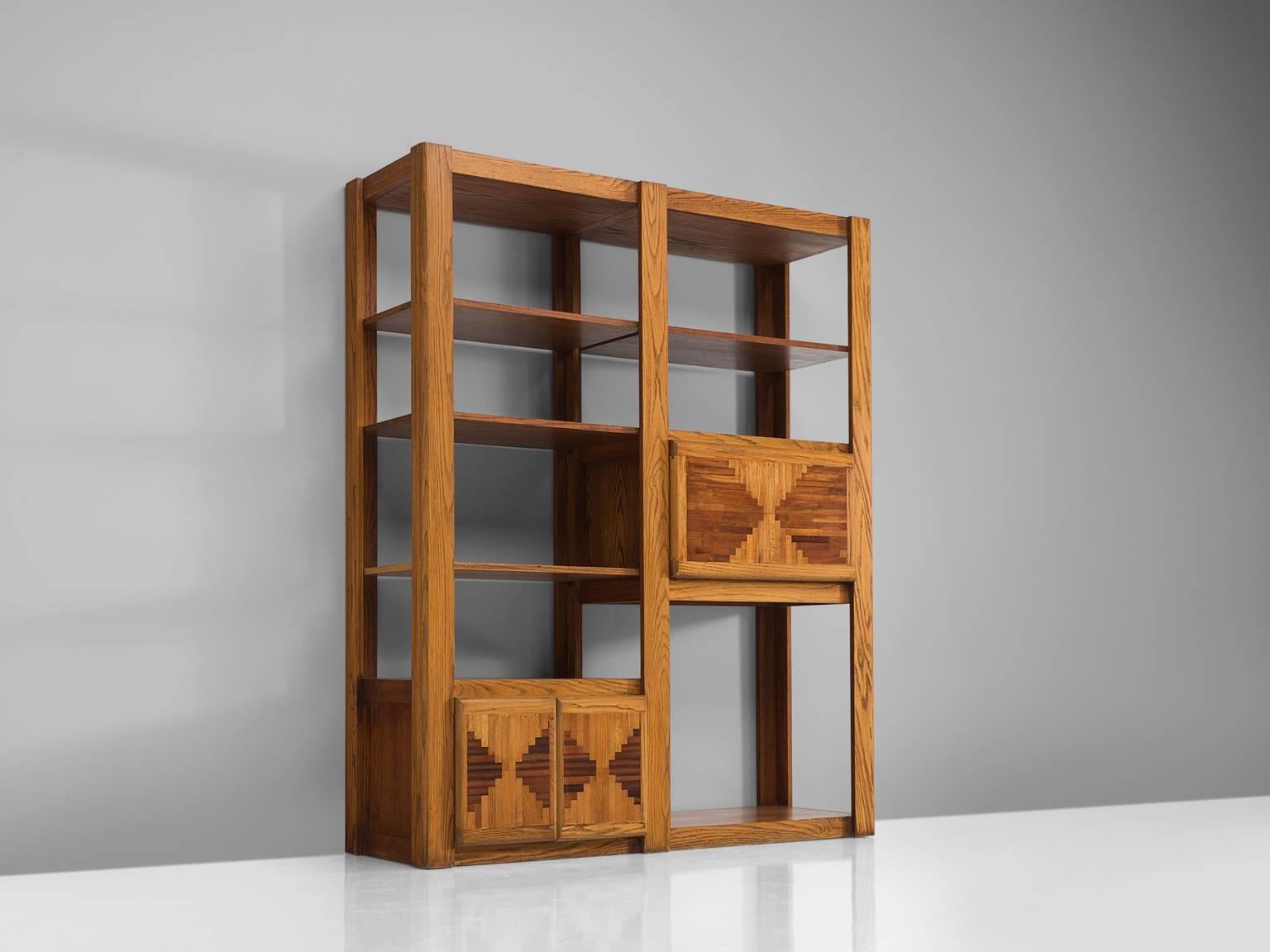 Bookshelf, walnut, beech, Italy, 1950s.

This grand, playful chest is custom-built in the 1950s. The design of this original cabinet is original with a lower cabinet with two marquetry doors and a higher cabinet with a single marquetry door. The