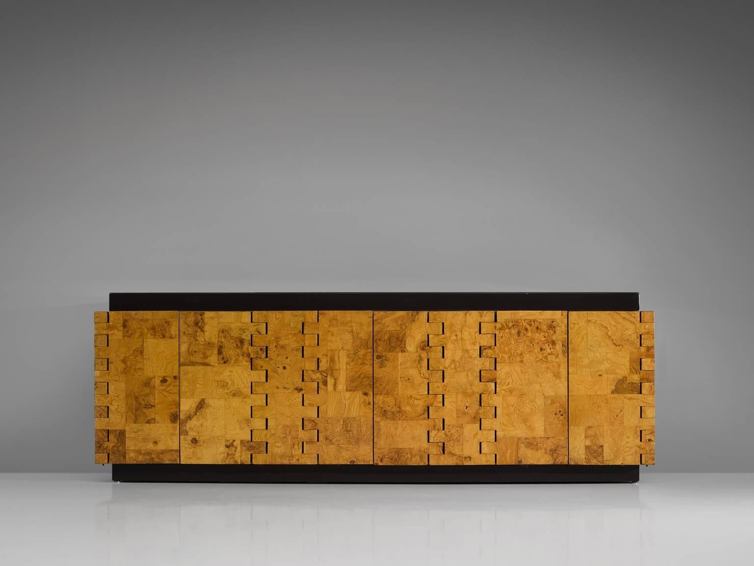 Paul Evans, cabinet model PE4, in burl, wood and glass, United States, 1970s. 

Burl sideboard by American designer Paul Evans. This cabinet shows a patchwork motive of olive burl wood. Evans is known for the use of patchwork, especially on his