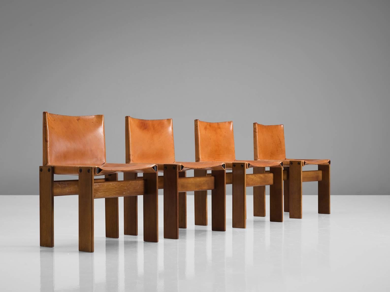 Dining chairs by Arfa & Tobia Scarpa, walnut and cognac leather, Italy, 1974.

These four chairs are strong and sturdy in their design. The wonderfully warm patinated leather is very well suited to the dark, aged oak. Interesting is the 'flat'