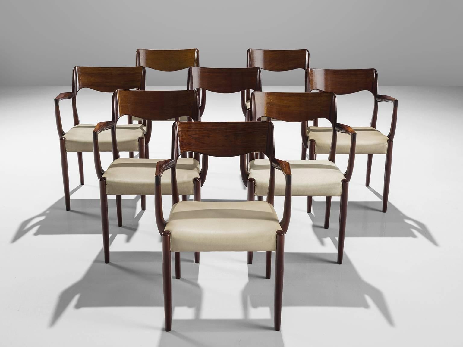 Set of eight armchairs, rosewood, seven in beige ecru faux leather and one in black leather, Denmark, 1950s
 
This set of chairs shows subtle lines and beautiful curves of the woodwork. The highly refined connections of the wood you can see the work