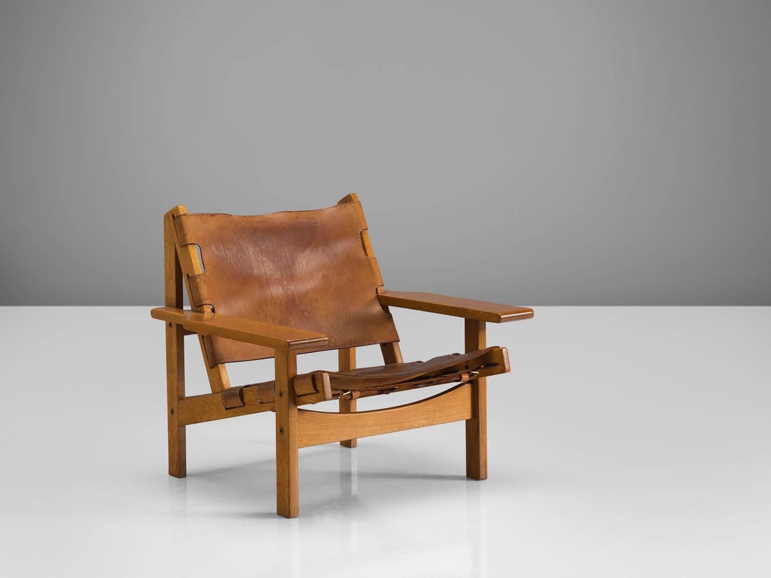 Erling Jessen, lounge chairs model 168, solid oak, leather, Denmark, 1960s.

This set shows exquisite Danish craftsmanship and aesthetics. The set features traits of hunting and a cabin lodge style thanks to its strong, sturdy character. The