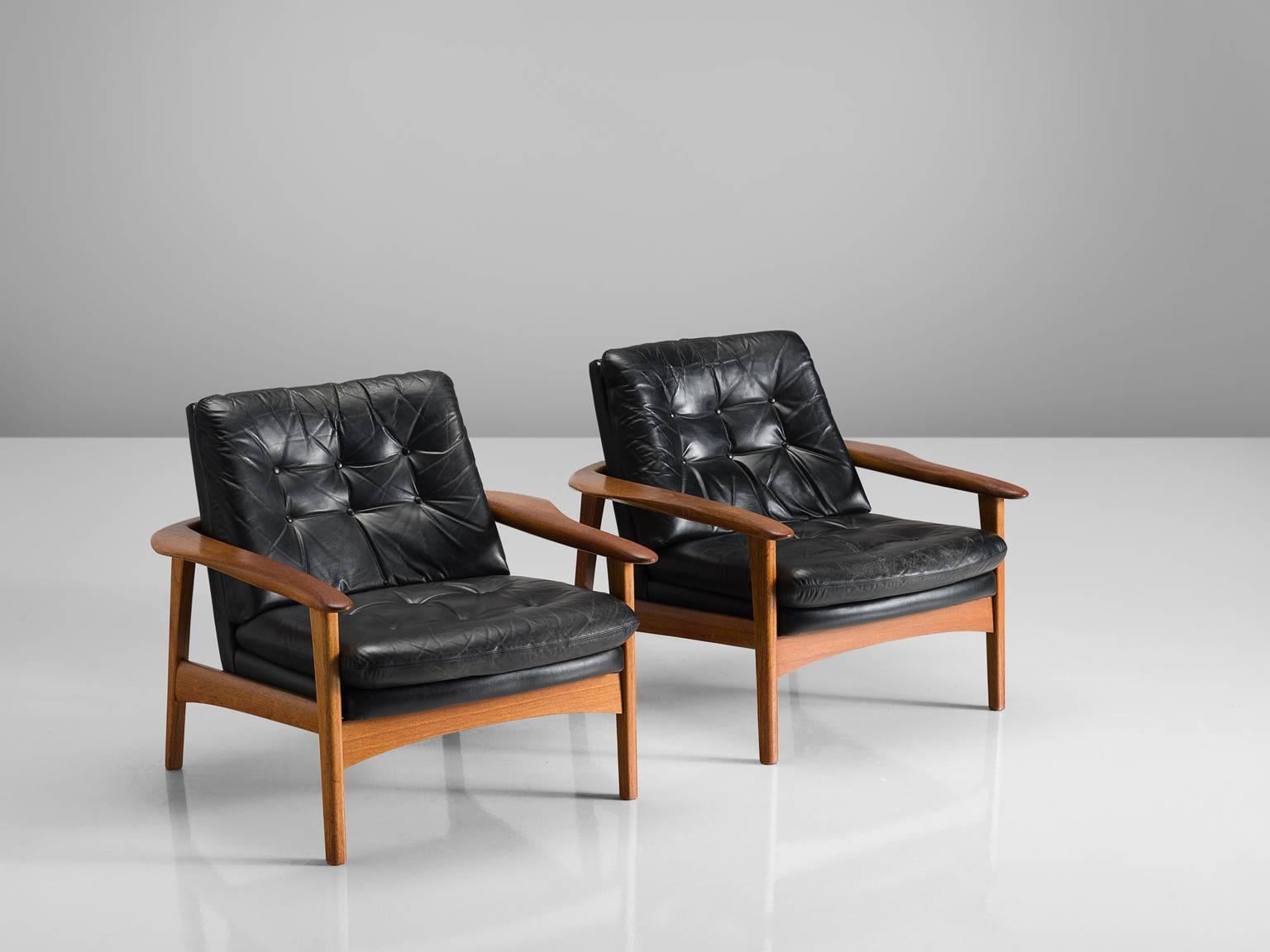 Pair of easy chairs, black leather and teak, Denmark, 1960s.

This set of club like easy chairs feature a teak frame with and a tufted back. The chairs are modest, and their prime feature is their comfortable leather shell. The tufted seat and