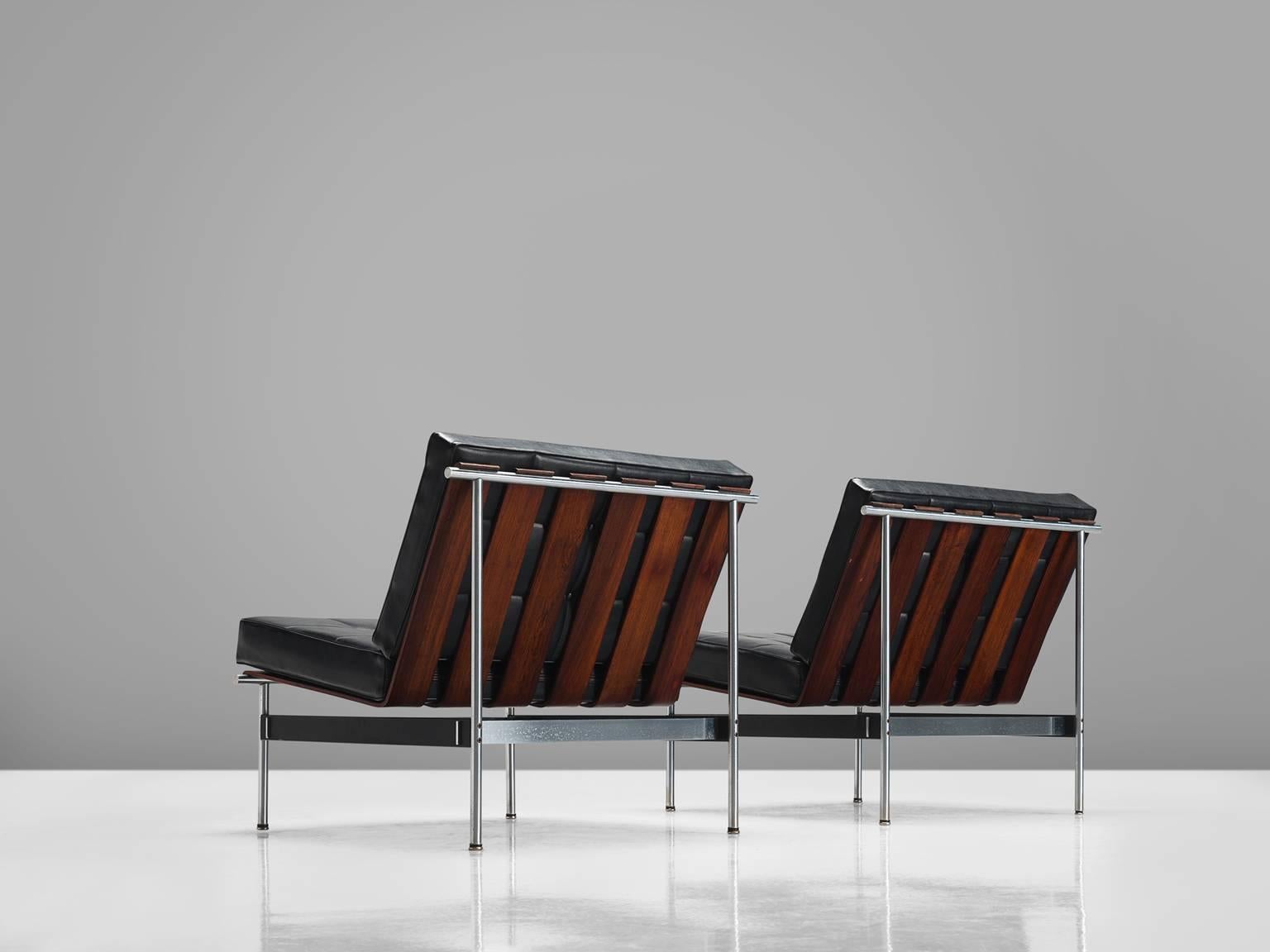 Kho Liang Ie for Artifort, easy chairs, rosewood, metal, black faux leather, the Netherlands, 1959.

The design of these lounge chairs modern, simplistic and features a combination of materials that were specific for that time. The chair is made out